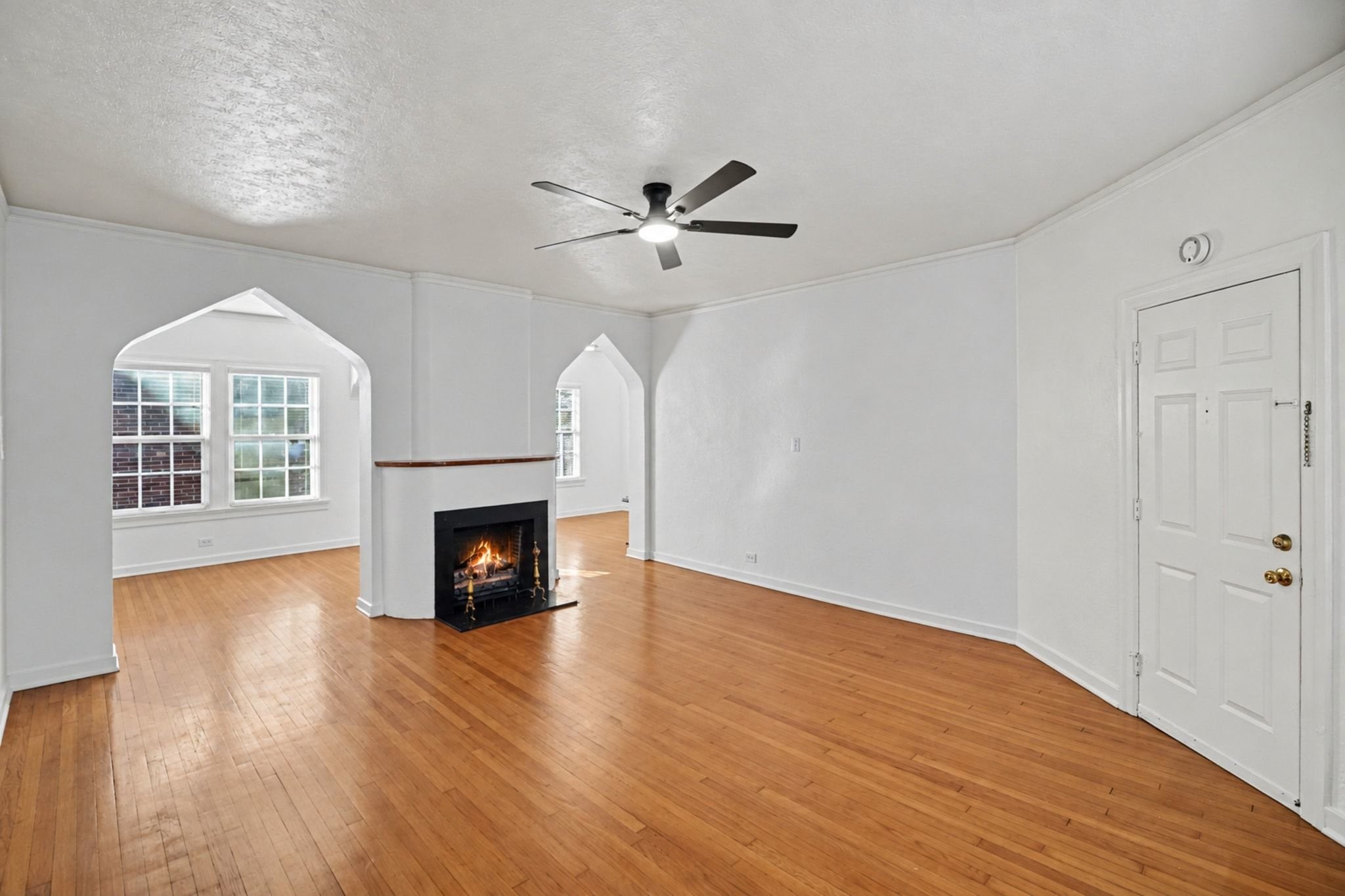 The spacious living room has a mock fireplace and original wood floors.