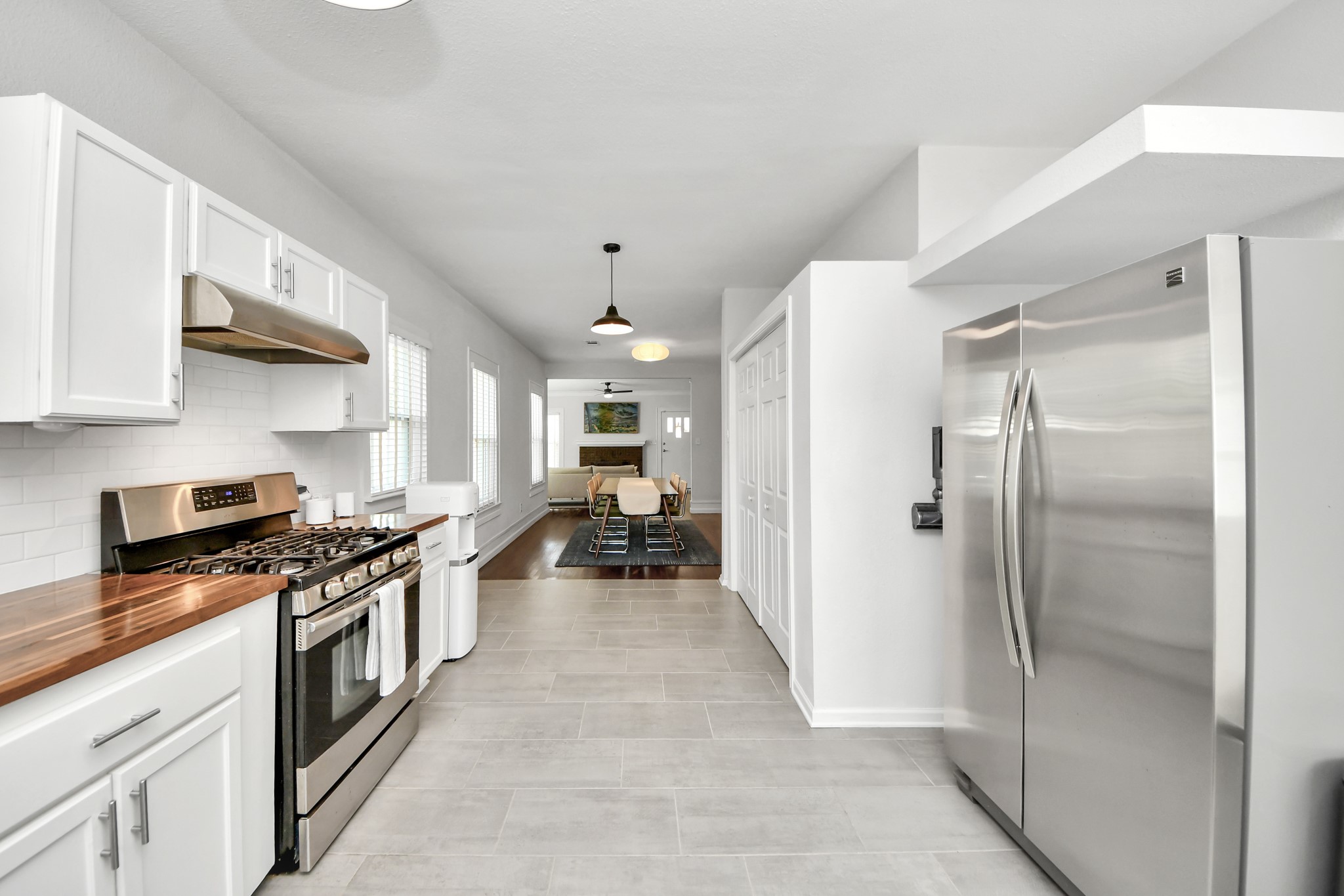 Designed for both everyday living and entertaining, this generously sized kitchen features stainless steel appliances, abundant cabinetry, and a spacious pantry for added convenience.