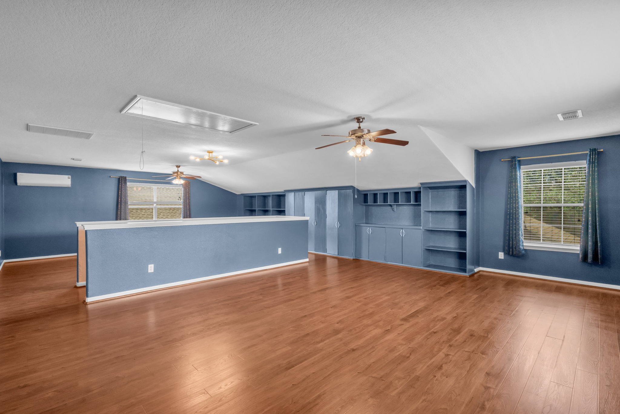 This upstairs loft also features convenient built-in bookshelves and storage cabinets.
