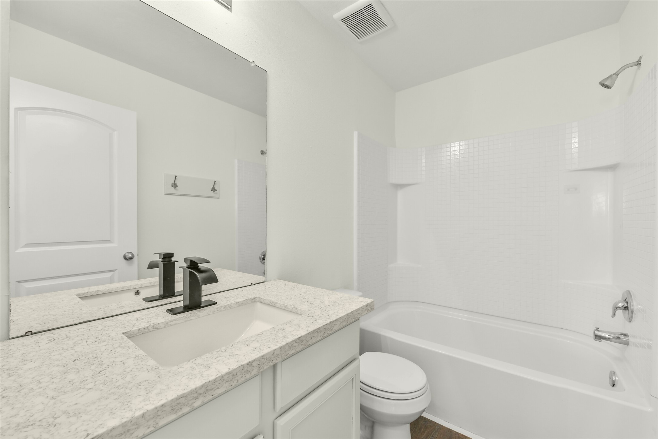 Recently updated bathroom with sleek quartz countertops and modern sinks.