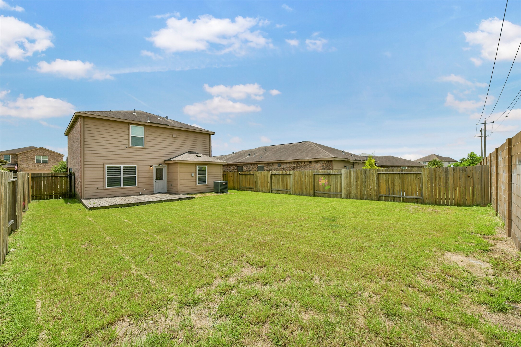 Fully enclosed backyard offering privacy and space for outdoor enjoyment.