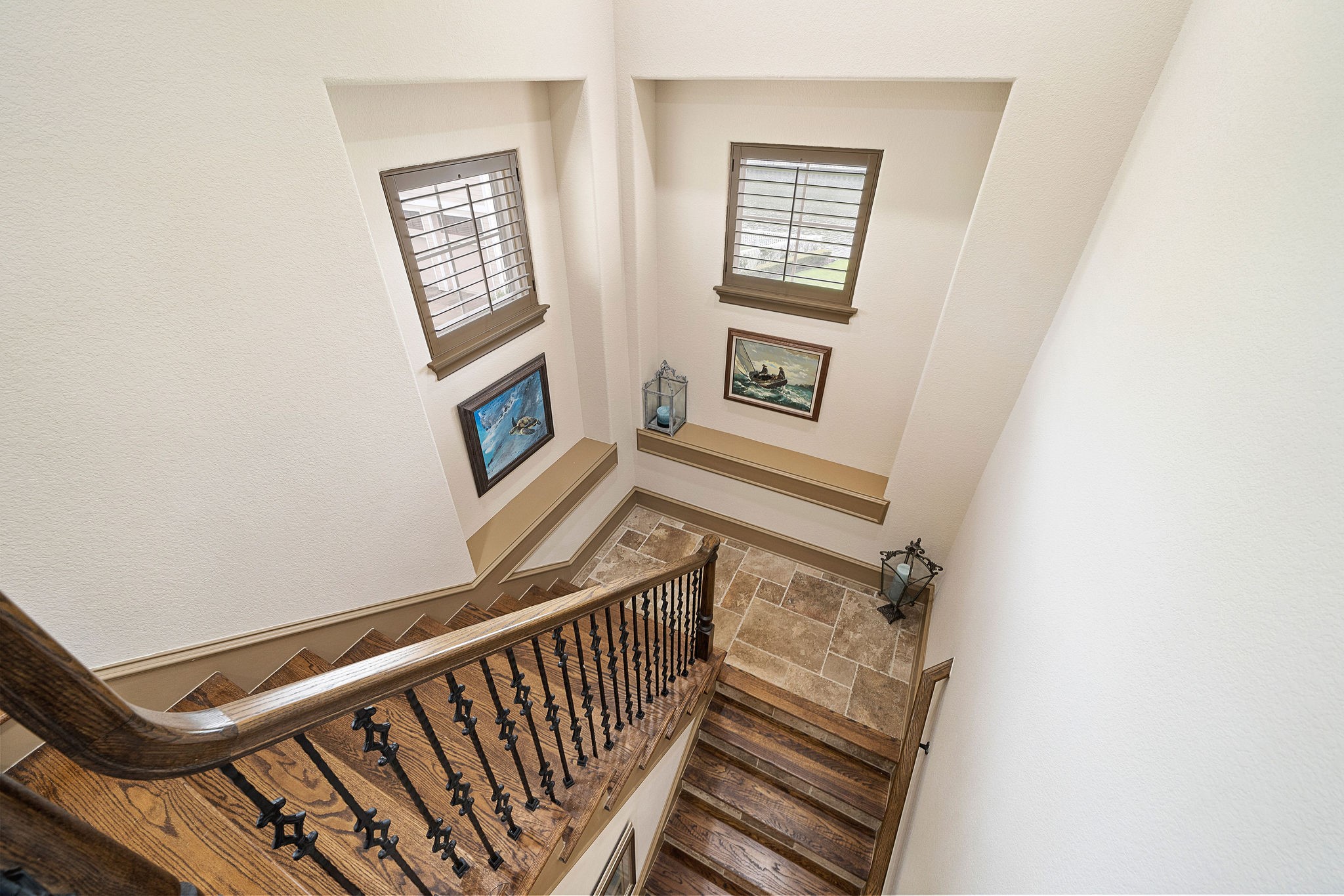 Elegant wood & travertine stairway with windows & shelving