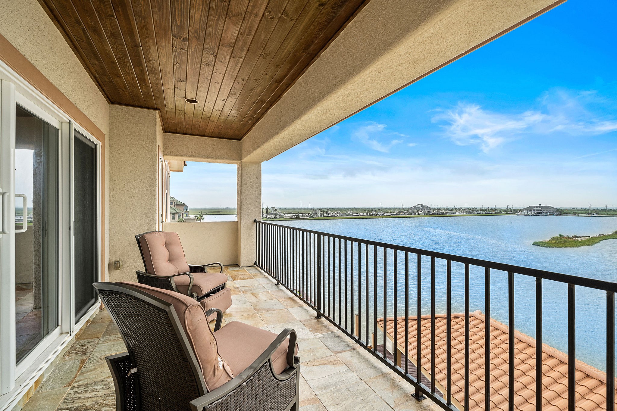 The third-level terrace, accessible from the game/media room, provides a peaceful retreat with panoramic waterfront views