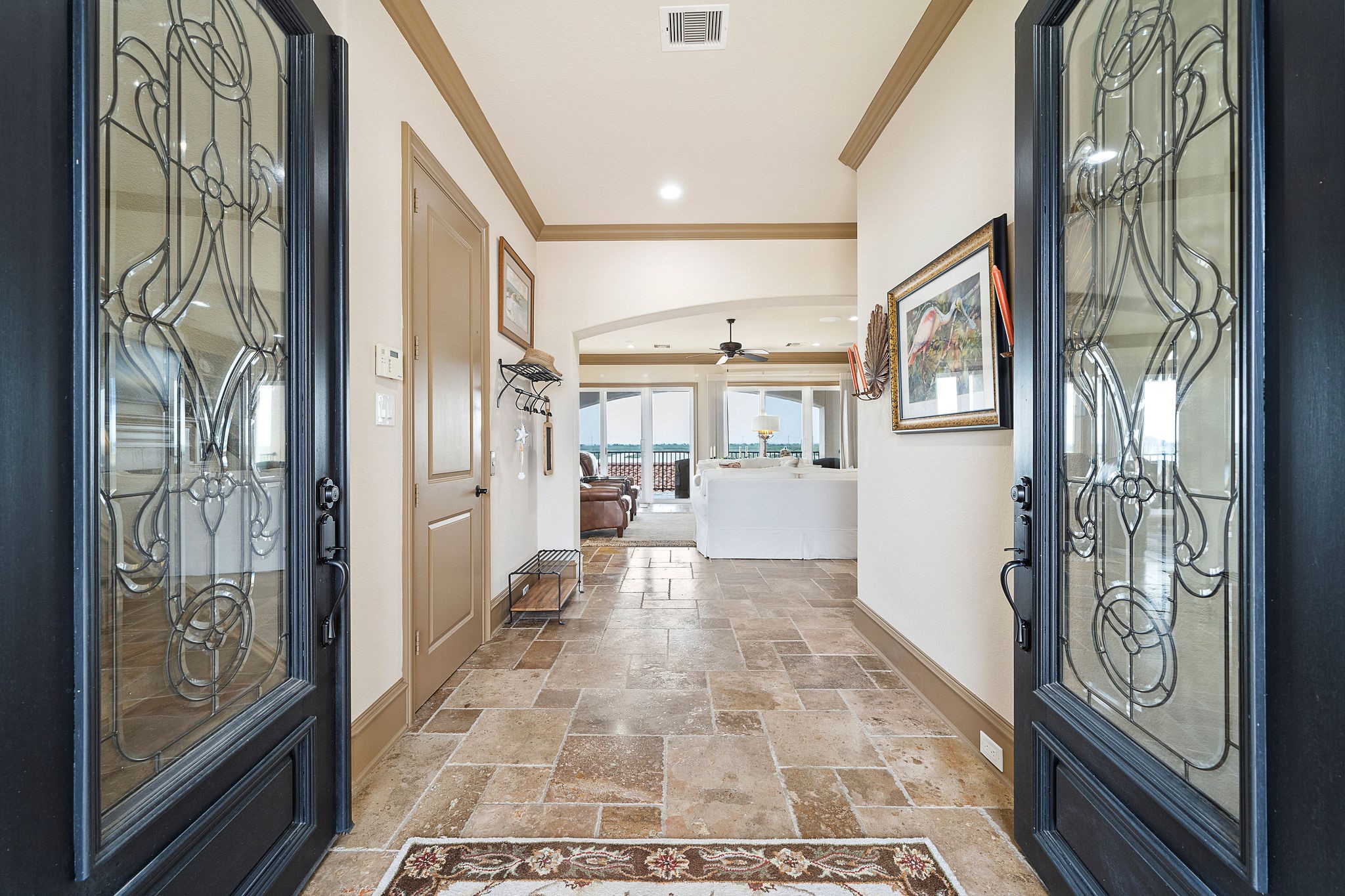 Stunning leaded glass front doors welcome you into a spacious and airy entryway