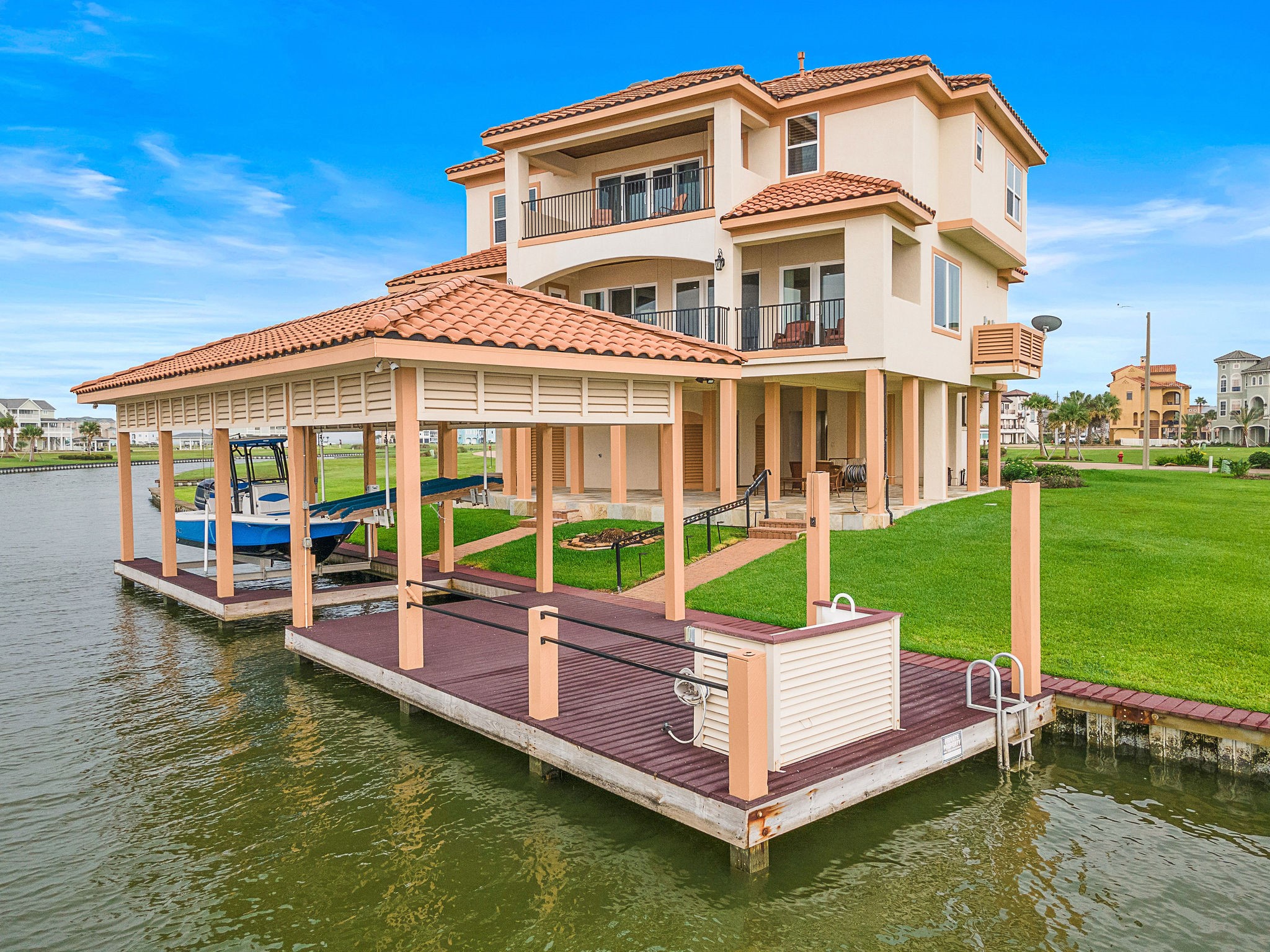 The beautifully manicured lawn, open dock area, and seamless indoor-outdoor living design make this home a rare gem in a premium waterfront setting