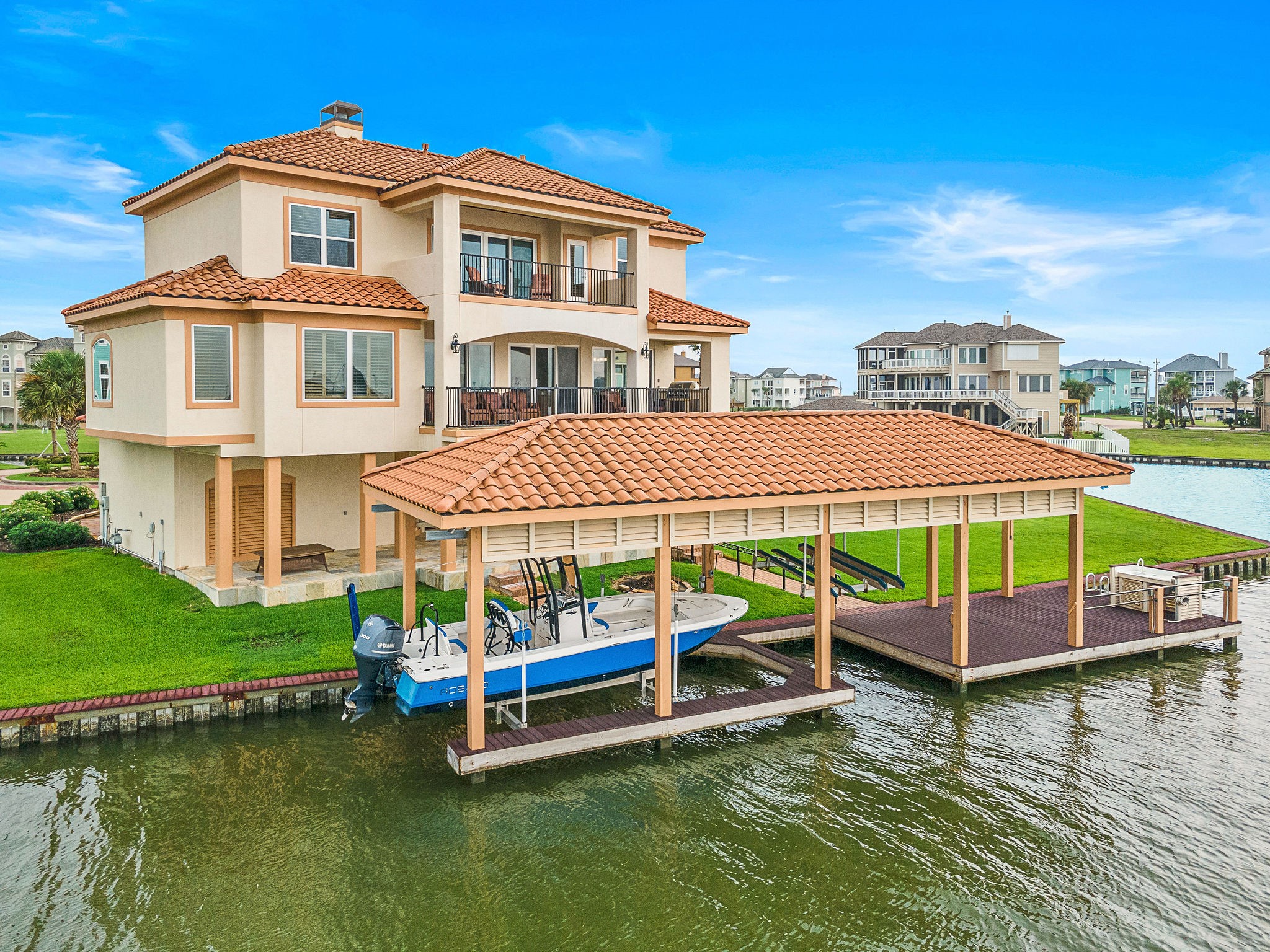 This Mediterranean-style waterfront home blends coastal elegance with relaxed luxury. With terracotta roof tiles, stucco exterior, and spacious balconies, it offers stunning canal views. Highlights include a covered patio, upper terrace, private boat slip with lift, and beautifully landscaped groundsperfect for indoor-outdoor living and entertaining