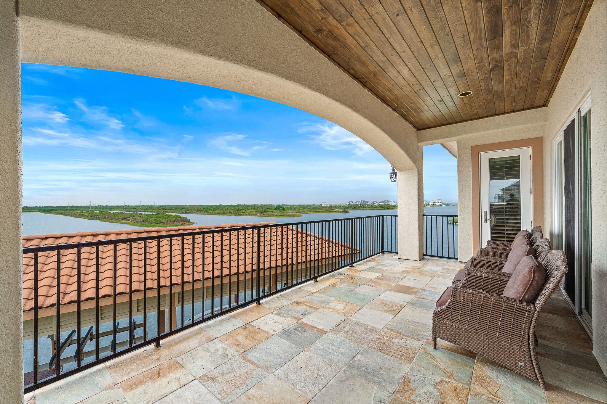Enjoy seamless indoor-outdoor living as the living room, kitchen, and primary suite all offer access to a covered terrace overlooking the Marina Channel and West Bay