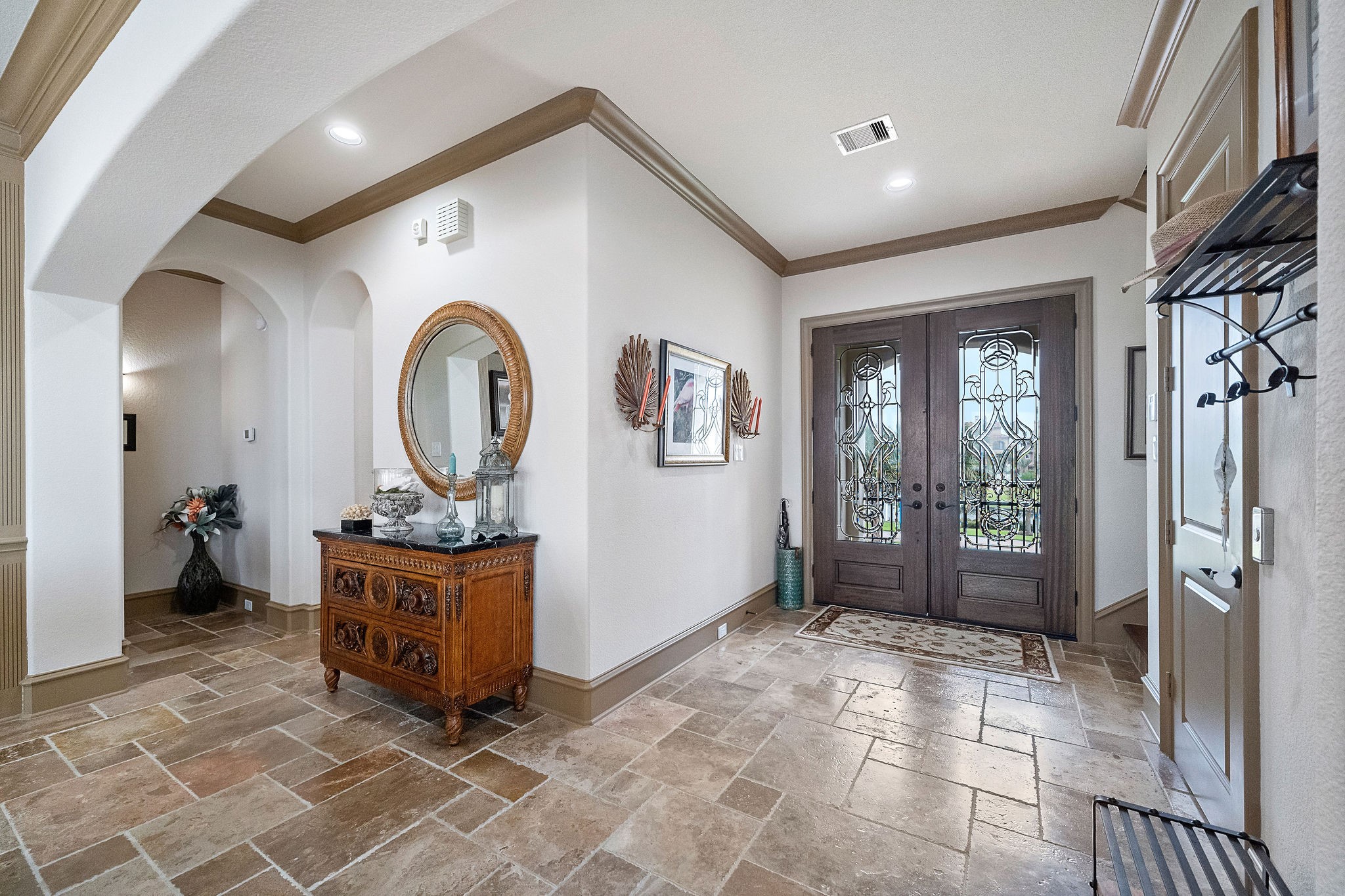 A welcoming travertine entrance with elevator to the right side of the photo. The elevator reaches all levels for convenience