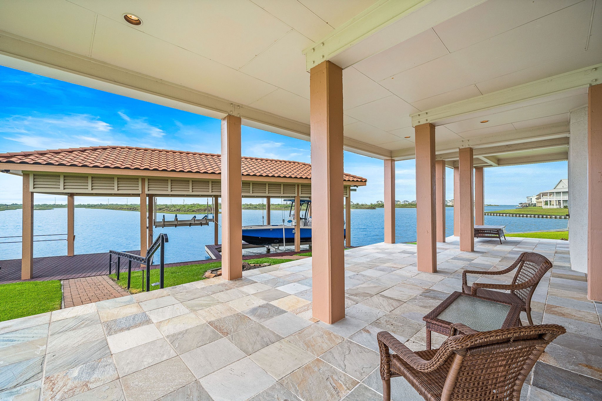 This home provides access to the backyard boathouse, with a direct path from the home leading to the water, making it ideal for boating and waterfront relaxation