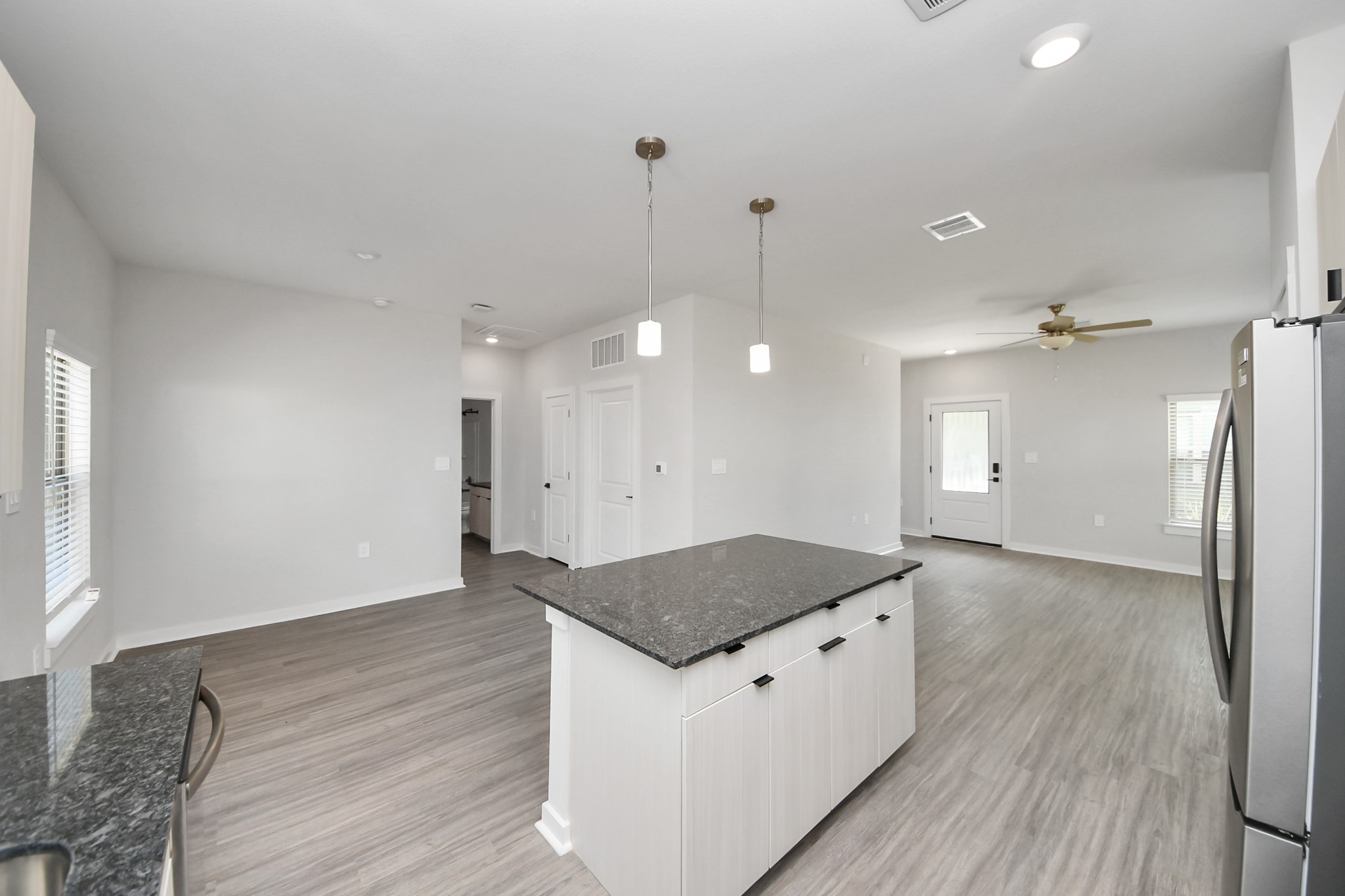 Boasting luxury finishes-stylish Island kitchen,granite counters,subway tile backsplash,ample custom cabinet space,stainless appliances,refrigerator,full size washer&dryer included,wood-like flooring throughout,open concept floor plan.