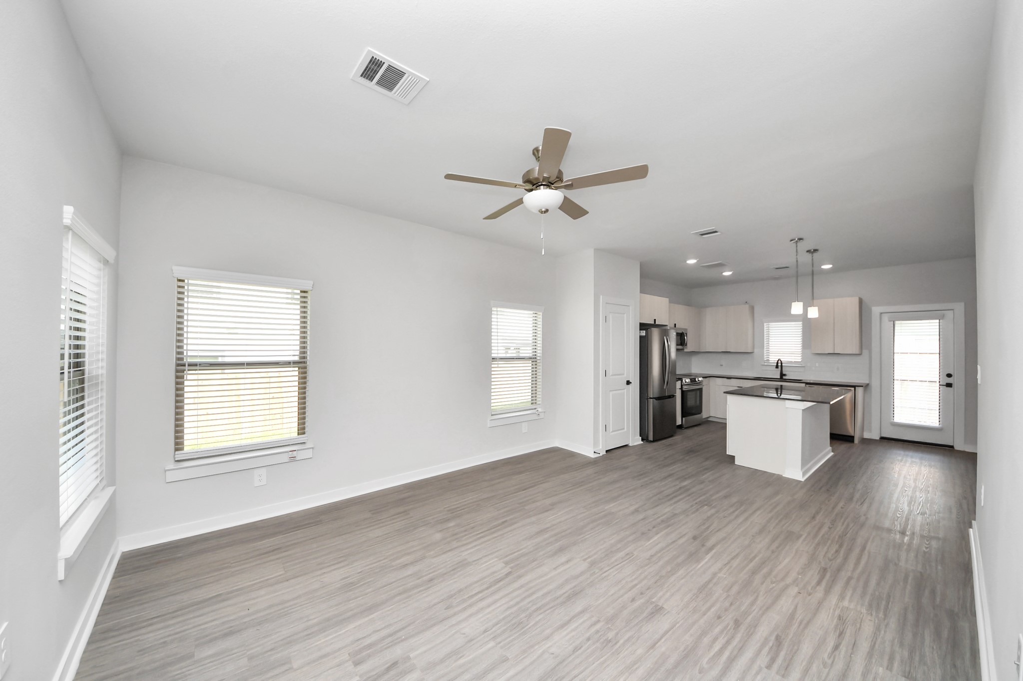 Boasting luxury finishes-stylish Island kitchen,granite counters,subway tile backsplash,ample custom cabinet space,stainless appliances,refrigerator,full size washer&dryer included,wood-like flooring throughout,open concept floor plan.