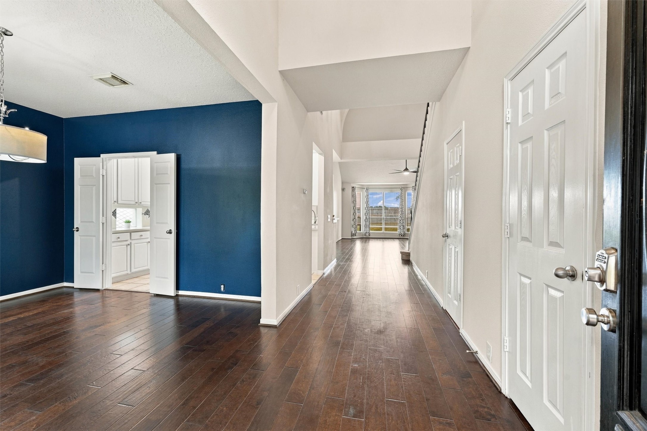 Spacious formal dining room featuring engineered hardwood flooring and elegant architectural details.