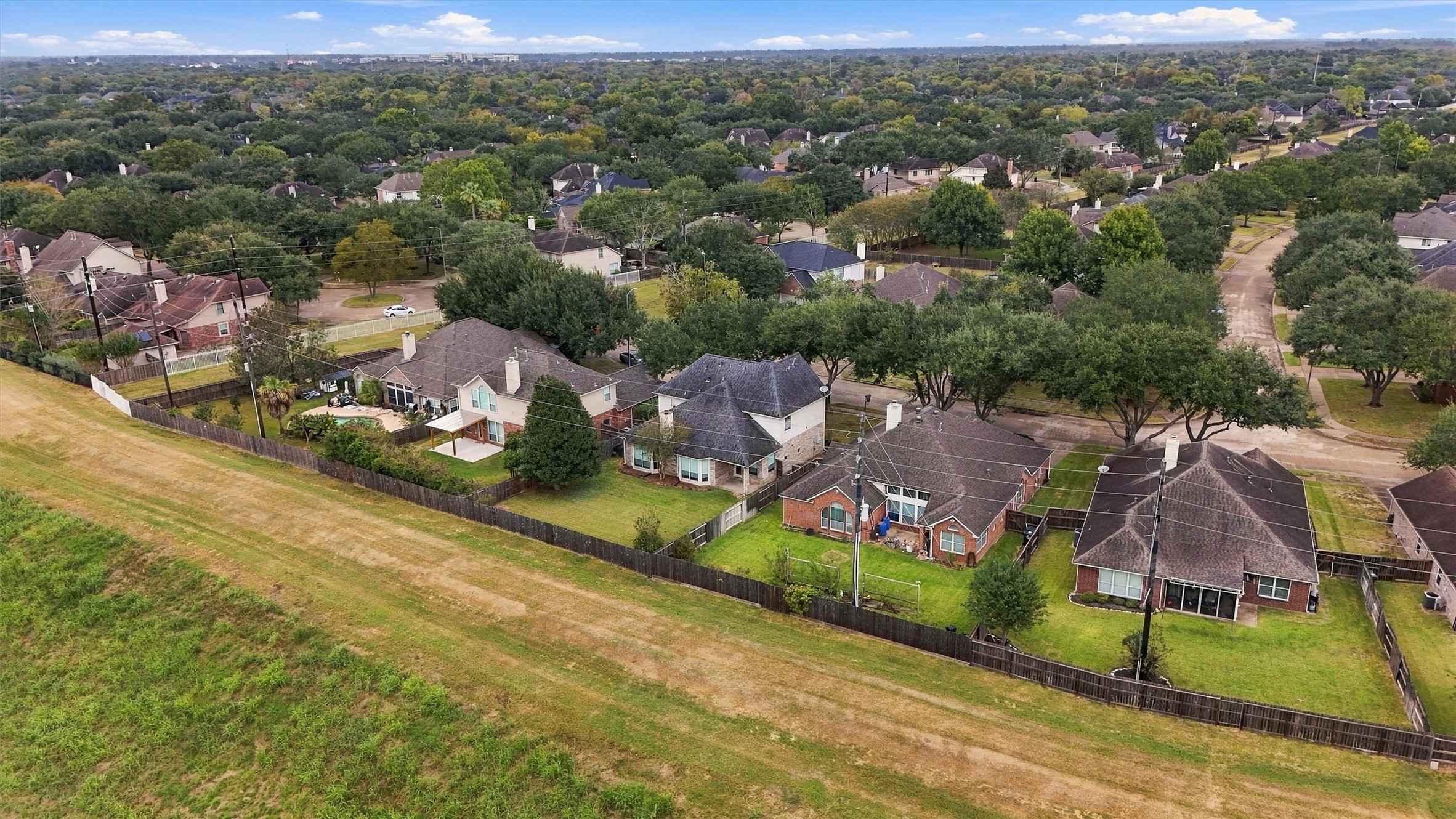 Aerial view showcasing the home's location alongside expansive greenbelt space.