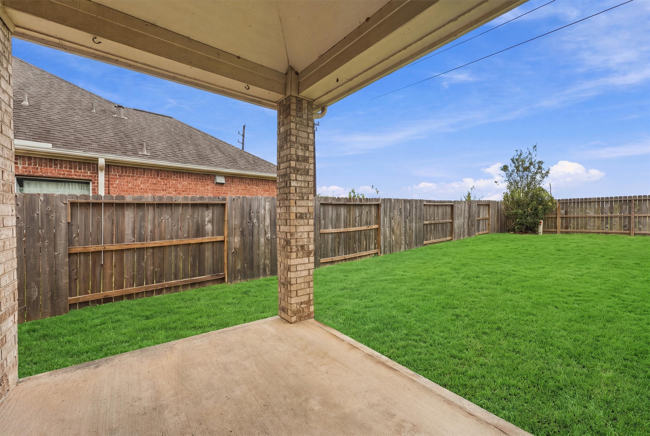 Covered back patio provides a comfortable space to relax and enjoy the outdoors.