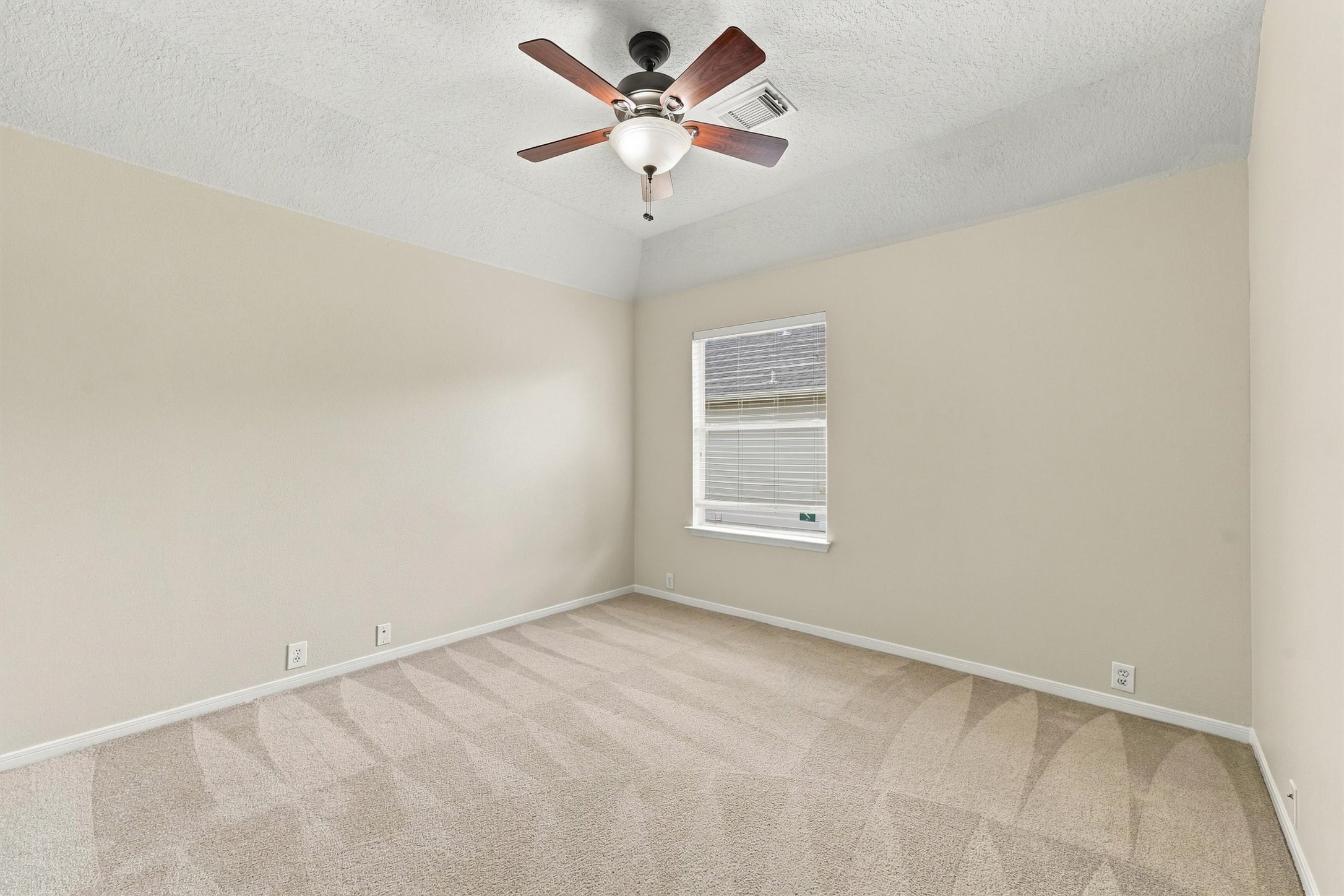 Additional secondary bedroom with a ceiling fan and neutral finishes.