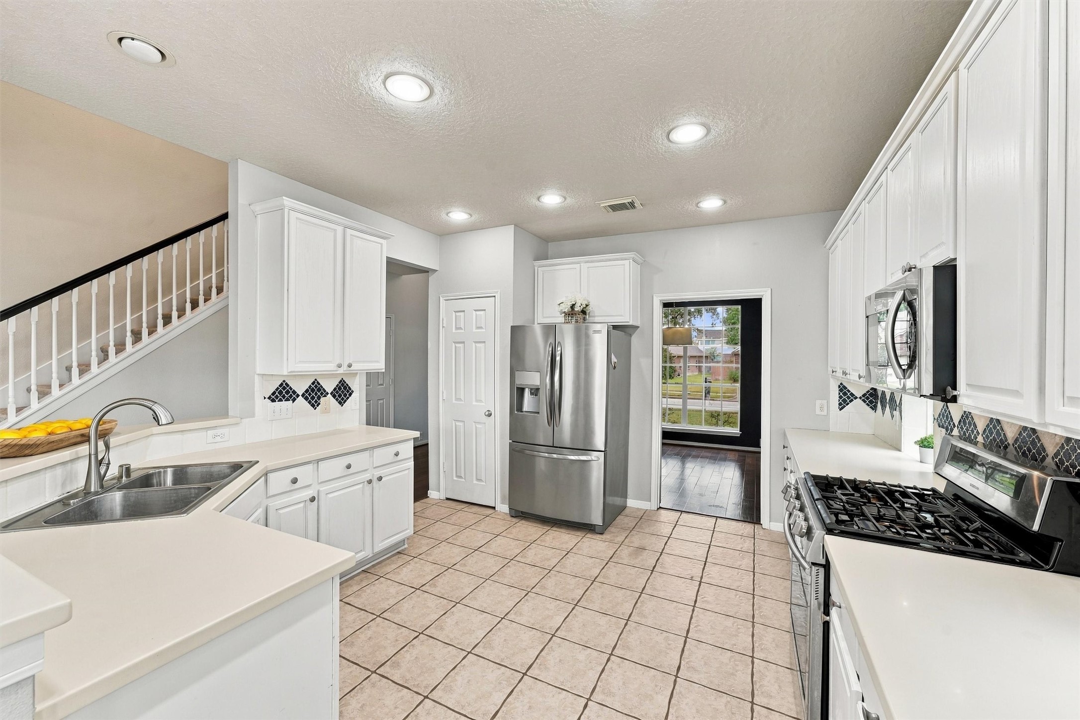 Spacious kitchen with a breakfast bar, ample cabinetry, and convenient access to the living areas.