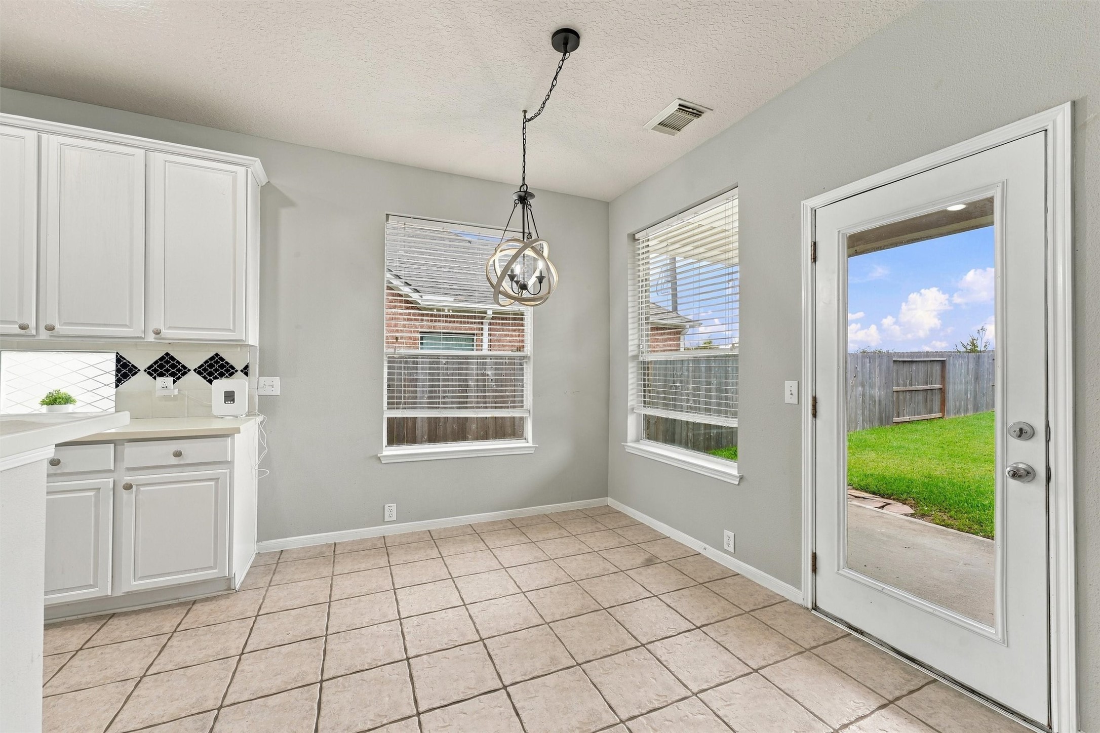 Light filled breakfast area overlooking the backyard with convenient access to the covered patio.