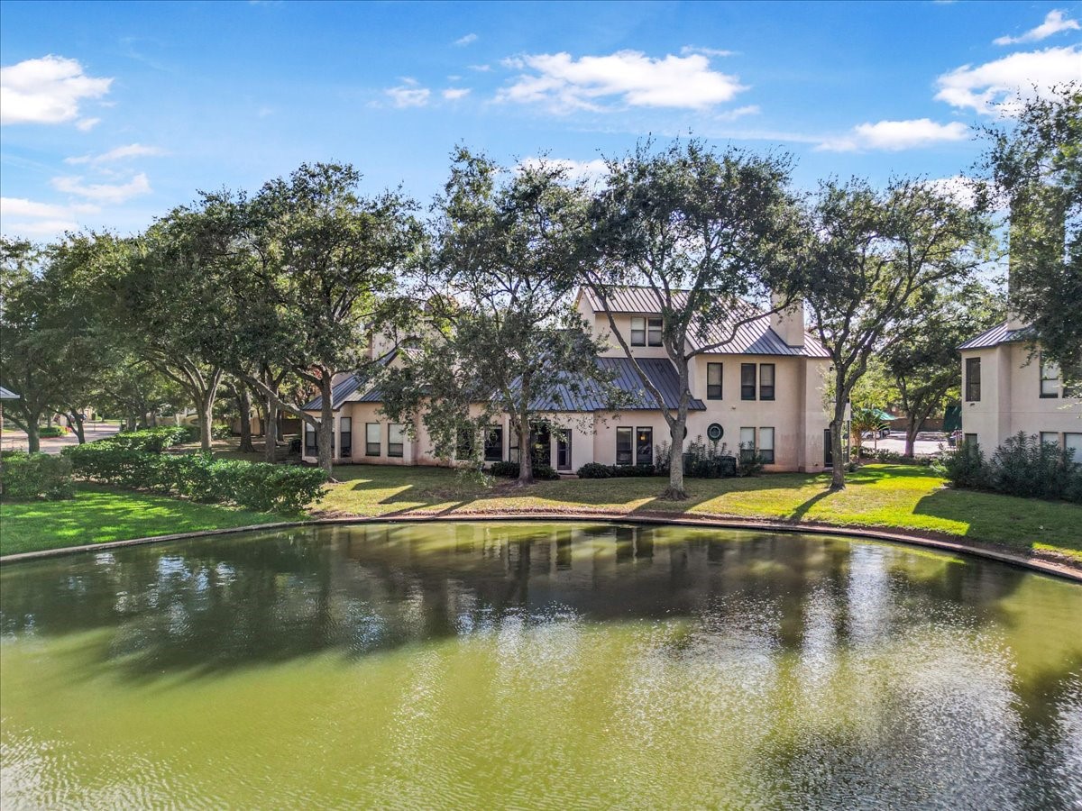 This photo showcases what you could walk daily, nestled among mature trees and overlooking a tranquil lake. The serene setting features lush greenery and a well-maintained landscape, providing a peaceful and picturesque environment.