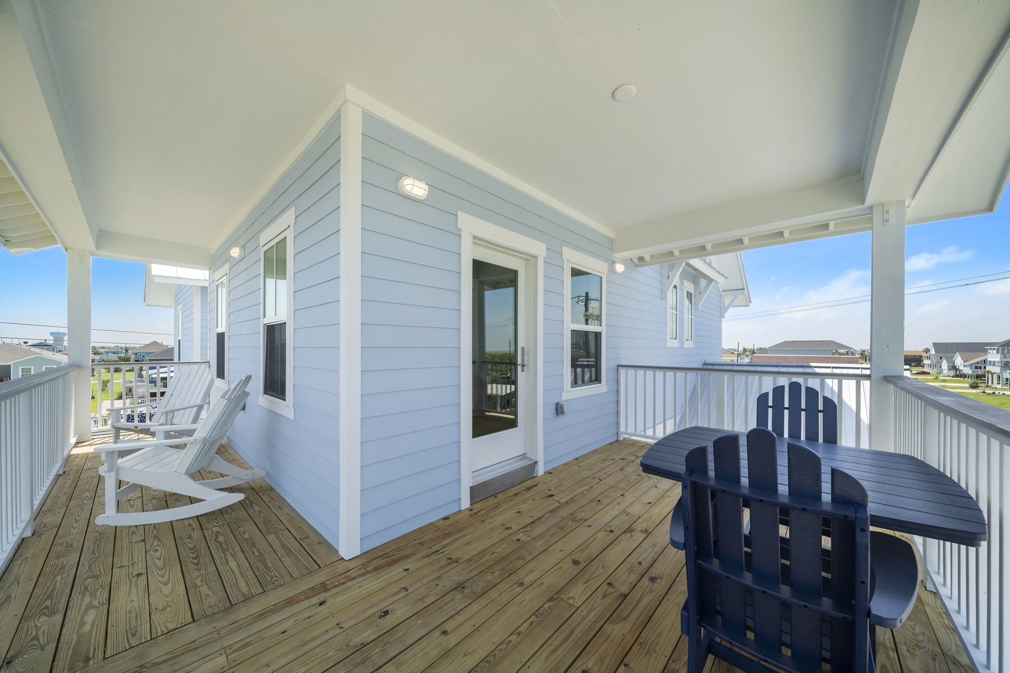 Charming wraparound porch with elegant white railings and inviting seating, perfect for enjoying the scenic views and outdoor relaxation. Charming wraparound porch with elegant white railings and inviting seating, perfect for enjoying the scenic views and outdoor relaxation.