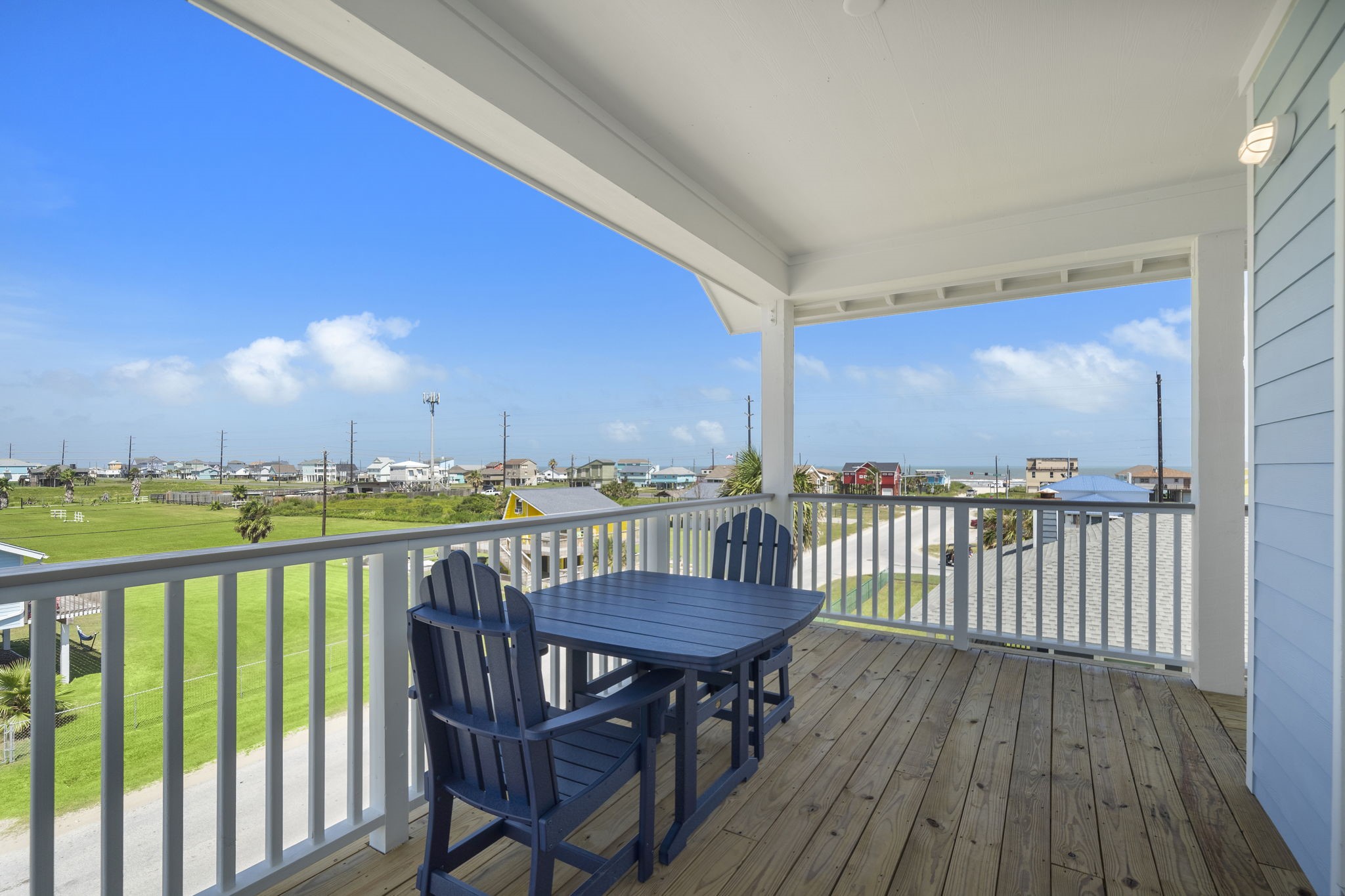 Enjoy stunning coastal views from this spacious, covered deck, perfect for outdoor dining and relaxation.