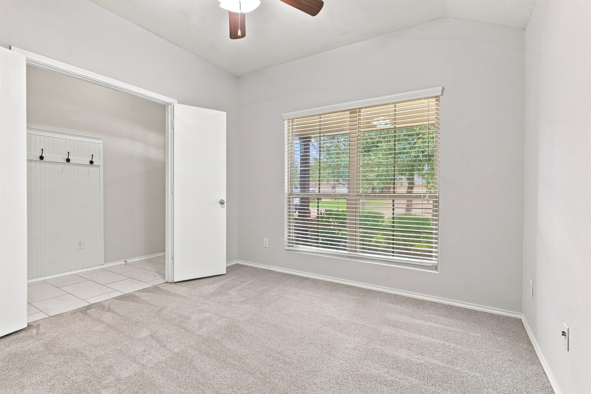 Study/home office with large front-facing window and convenient access to the entry, featuring a built-in coat rack with hooks. Study/home office with large front-facing window and convenient access to the entry, featuring a built-in coat rack with hooks.