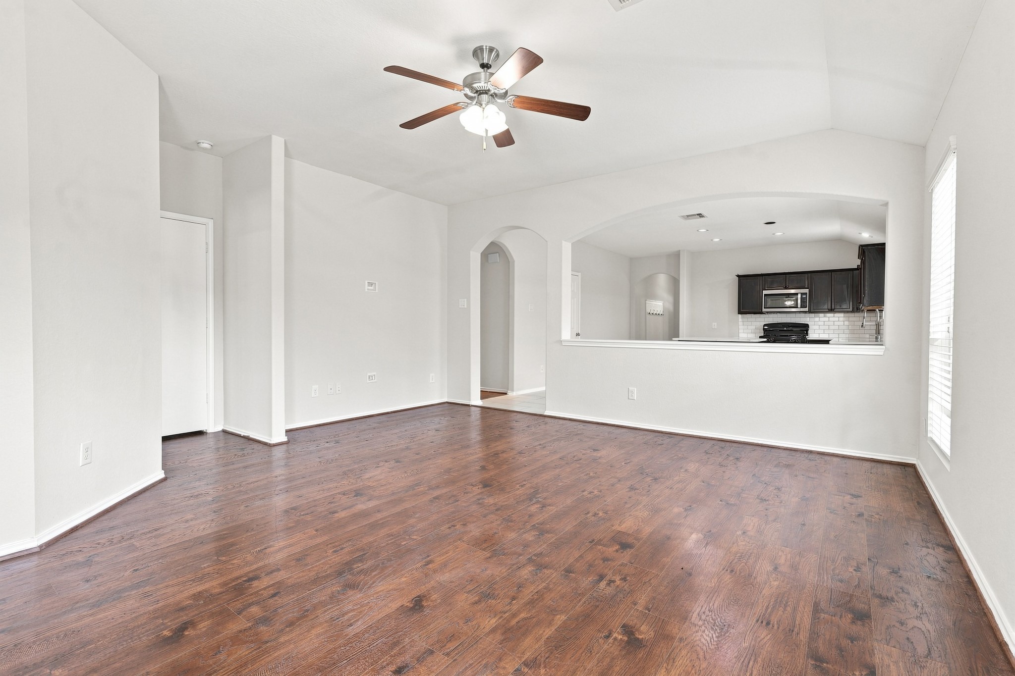 15. Additional living room view showcasing the open layout and pass-through to the kitchen and dining area.