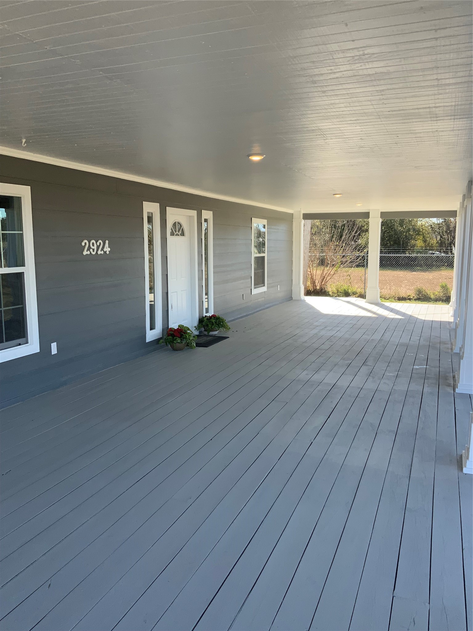 Relax to this inviting front porch and experience the beauty of Southern living