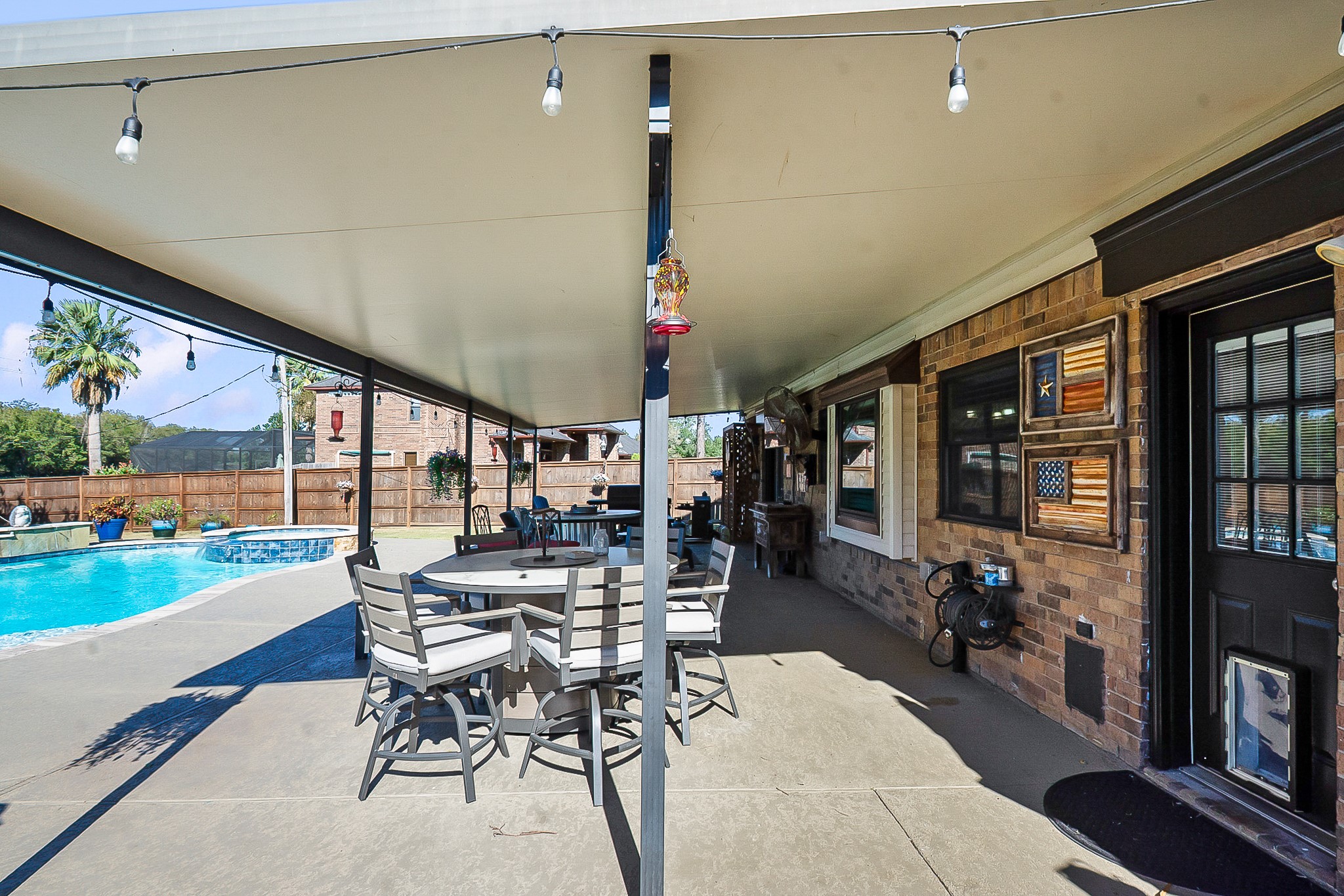 Experience outdoor living at its finest with a spacious 988 sq. ft. covered patio, perfect for dining and relaxing by the sparkling pool.