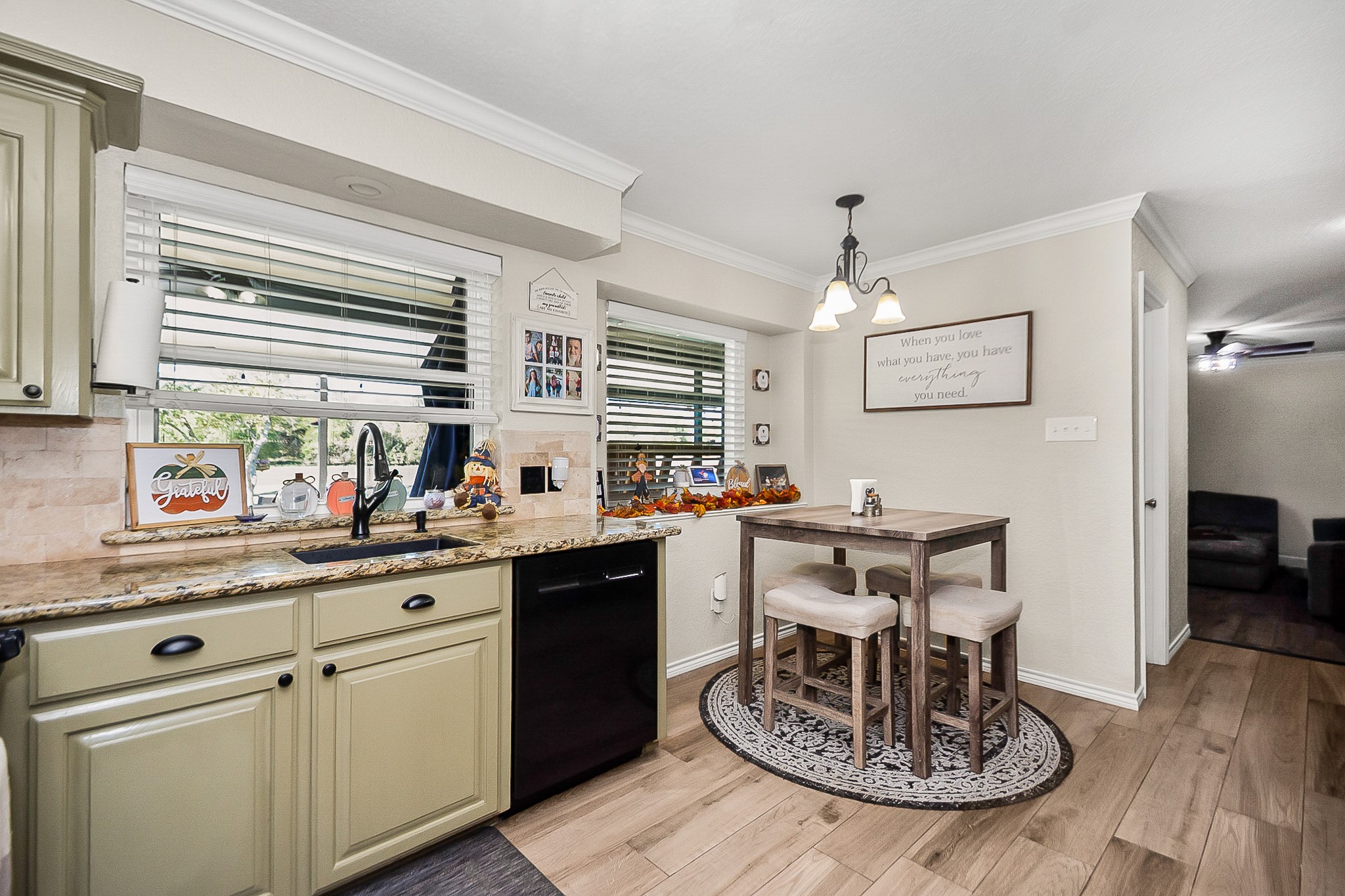 Charming kitchen with granite countertops, stylish cabinetry, and a cozy breakfast nook. The open layout and large windows fill the space with natural light.