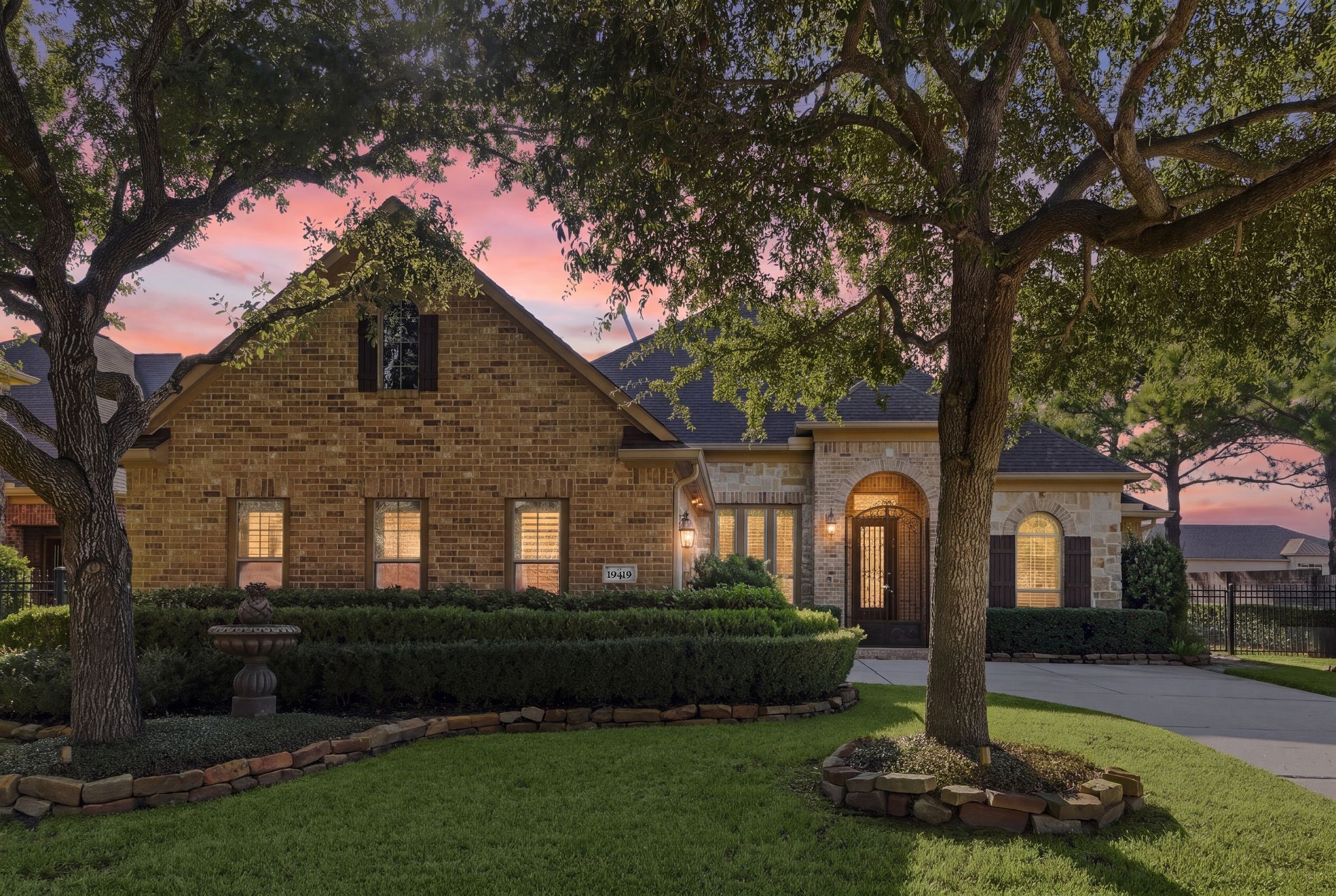 Charming patio home with elegant arched entryway, nestled among mature trees and lush landscaping. Charming patio home with elegant arched entryway, nestled among mature trees and lush landscaping.