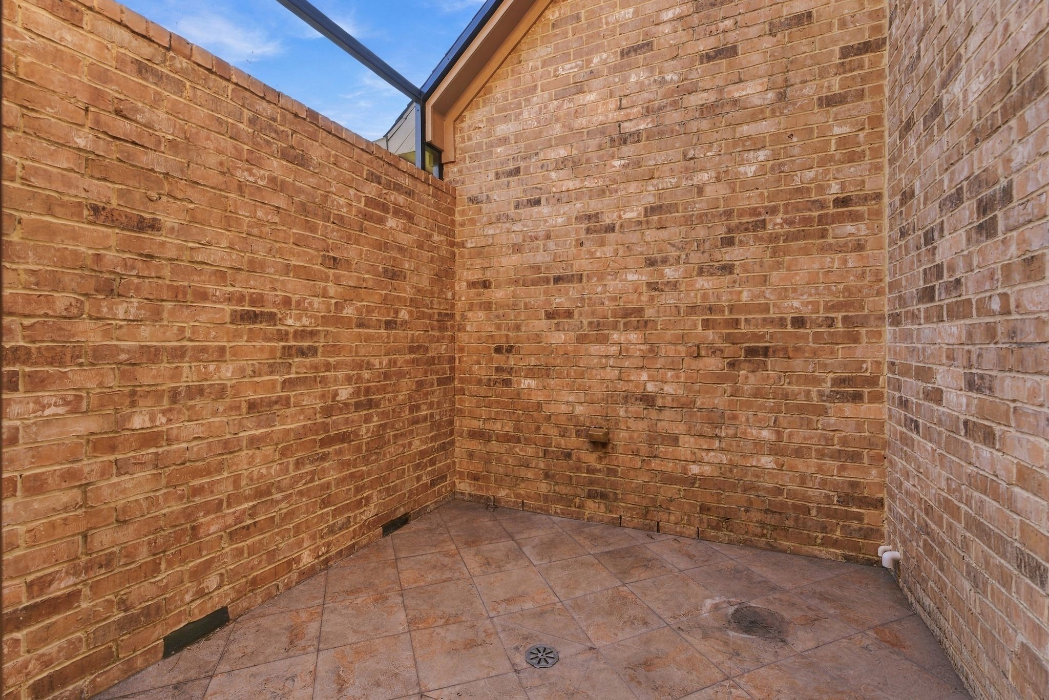Cozy brick courtyard perfect for a private outdoor retreat.