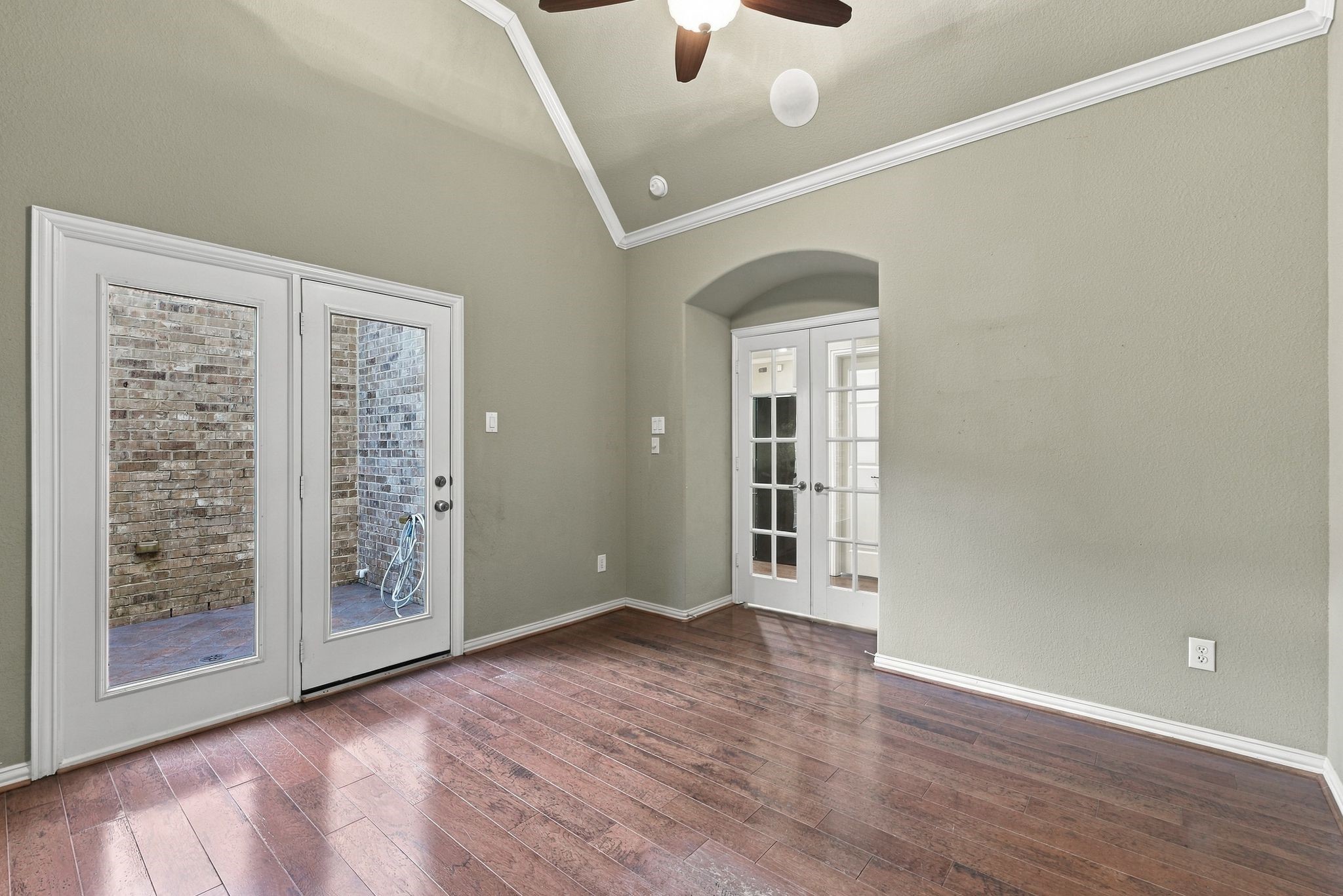 Bright and inviting room with elegant French doors offering easy access to a cozy outdoor space.