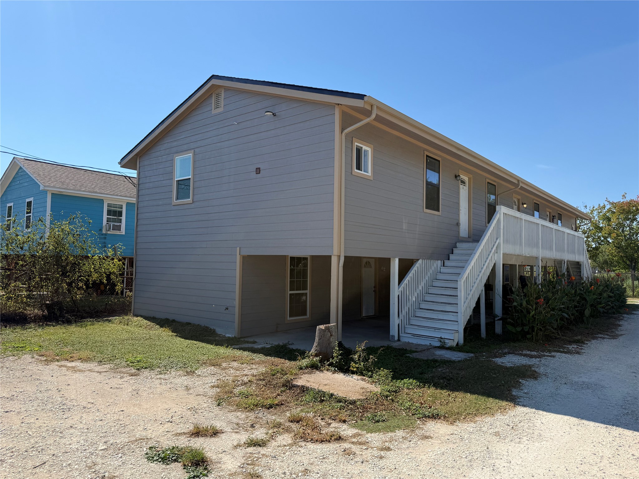 Freshly updated elevated building with staircase to Unit 1.