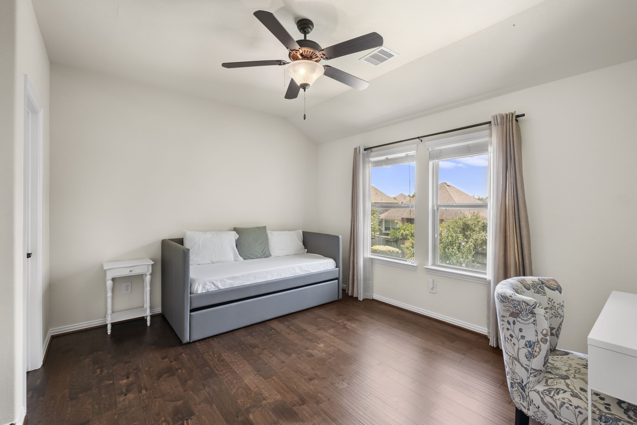 Spacious secondary bedroom with backyard views.