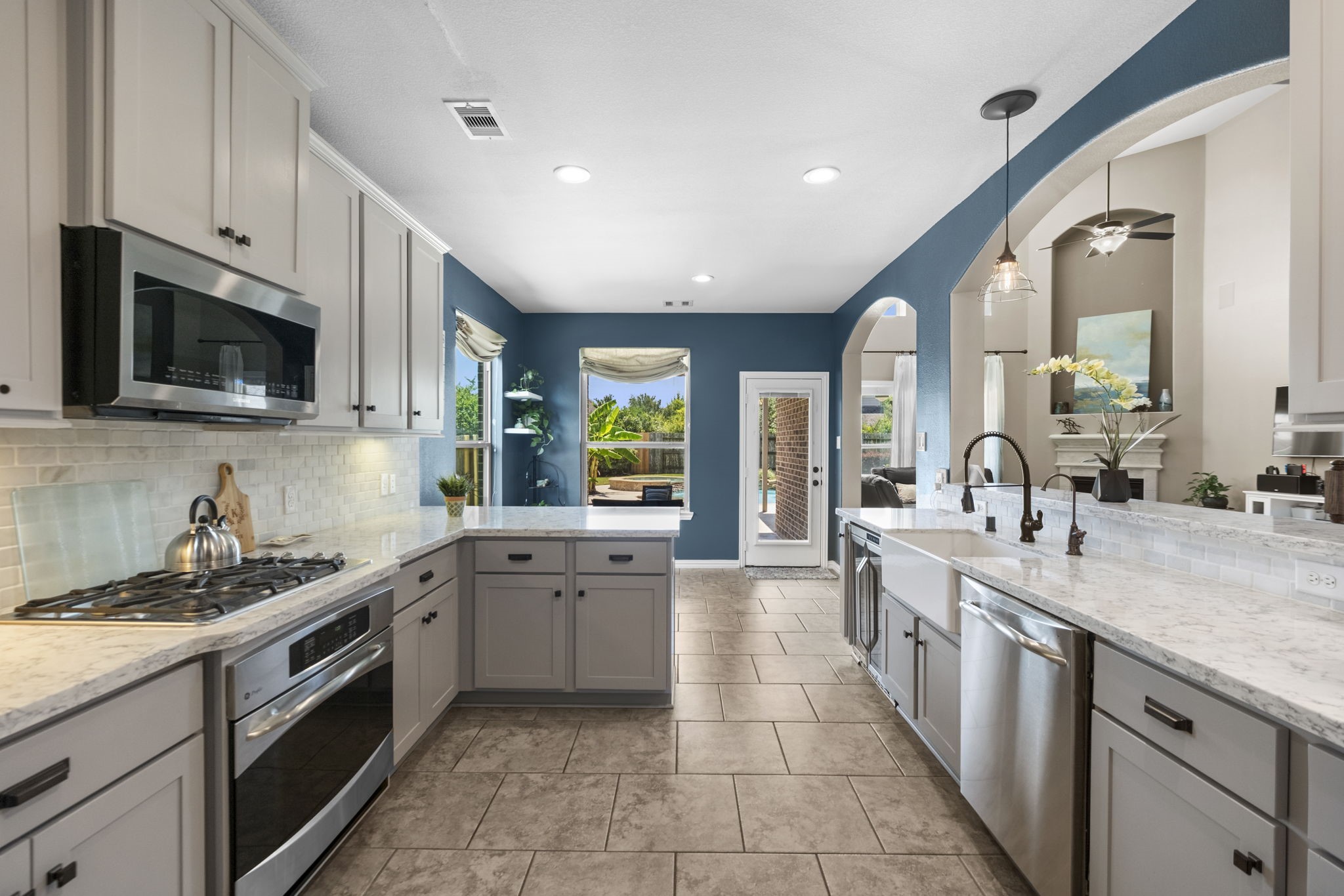This kitchen features modern appliances, spacious countertops, and sleek cabinetry. The room flows seamlessly into adjacent living areas, creating a perfect space for entertaining.