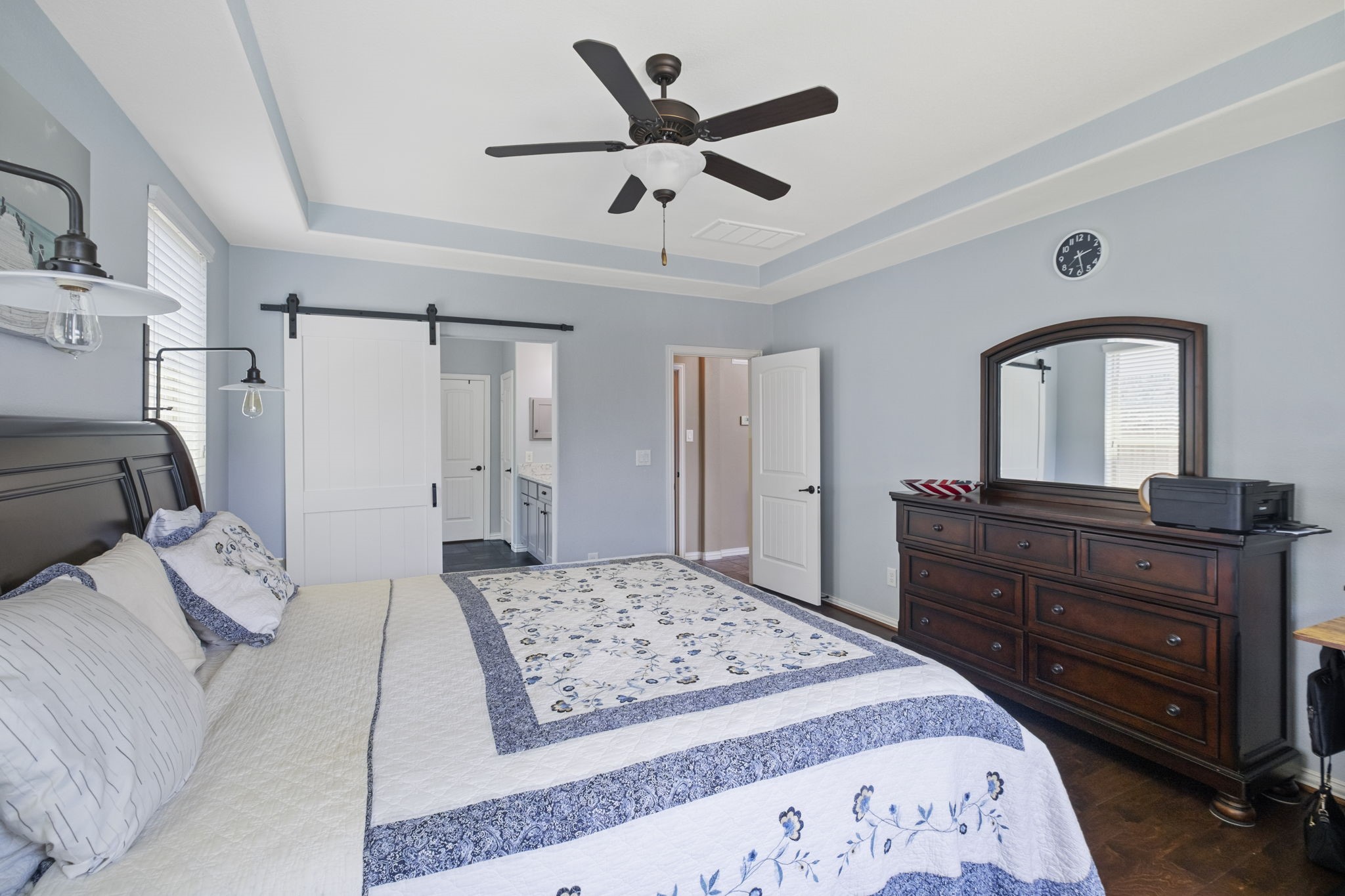 The barn door creates a privacy to the primary bathroom.