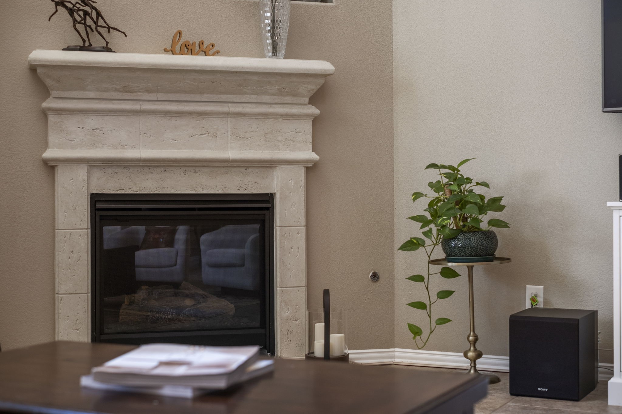 Cast stone gas log fireplace creates a cozy atmosphere during those cooler winter nights.