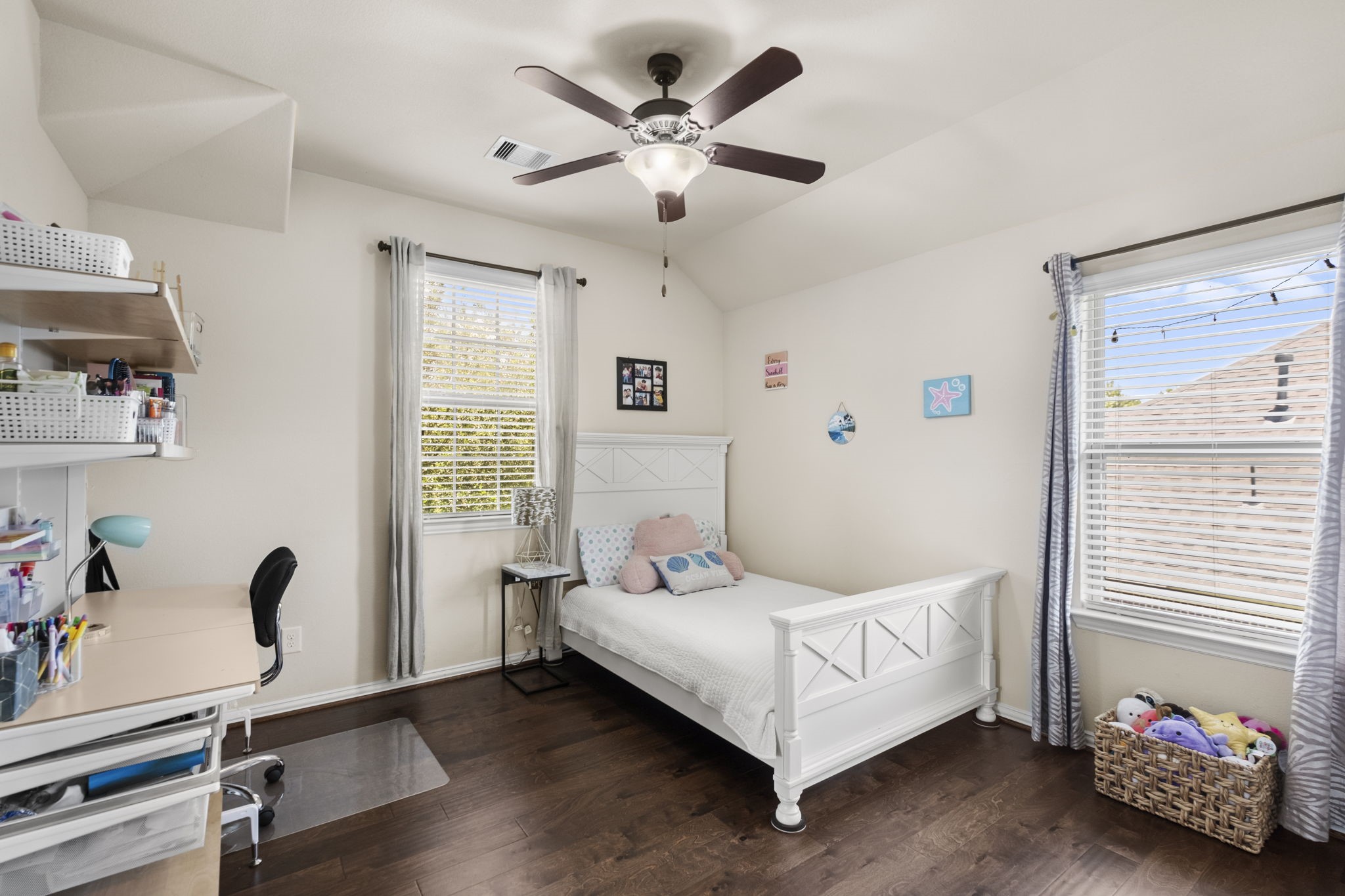 Another spacious secondary bedroom with wood floors overlooks the front yard.