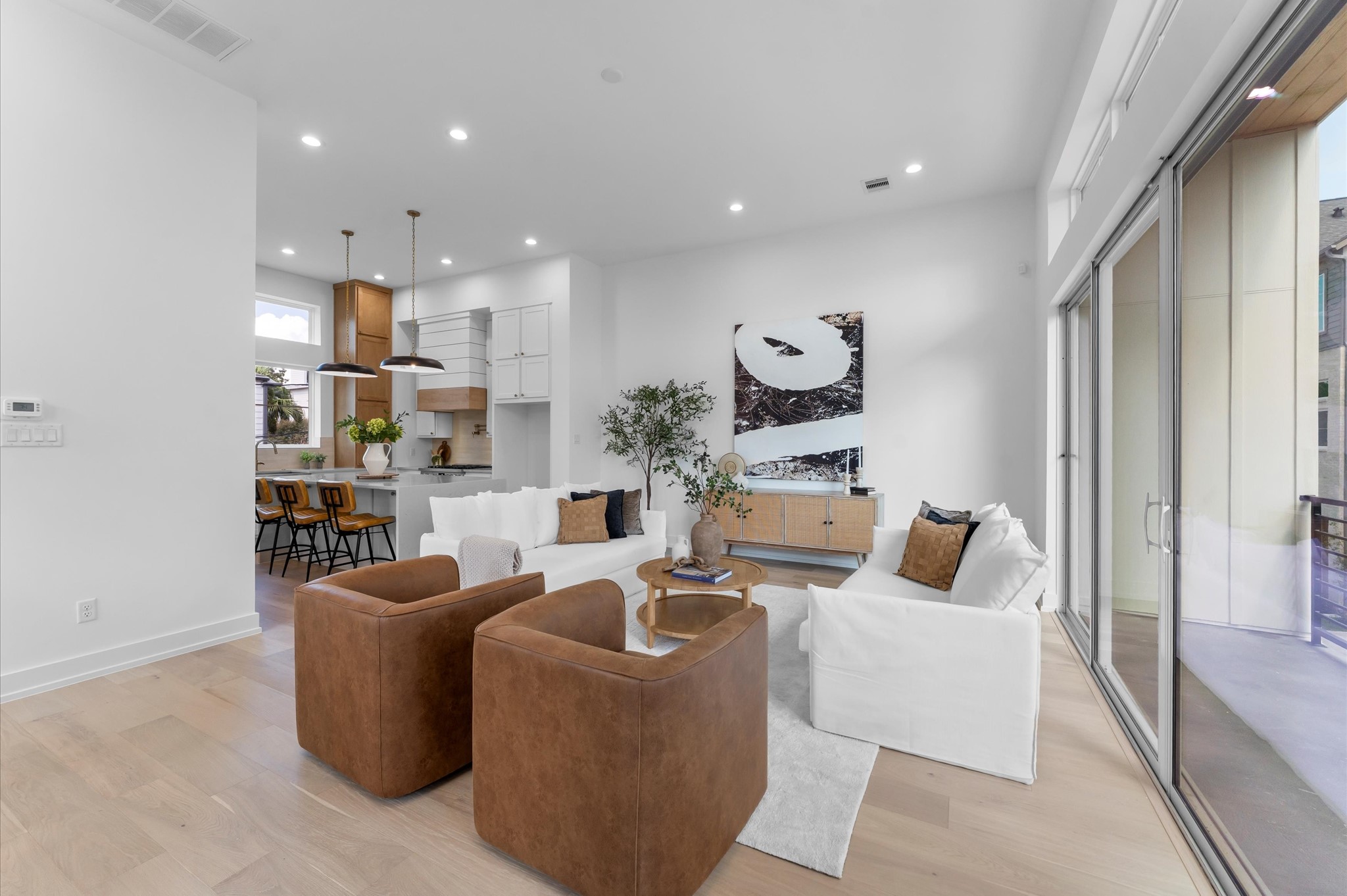 Bright, open living area with soaring ceilings, sliding glass doors and seamless flow to the covered outdoor living space.