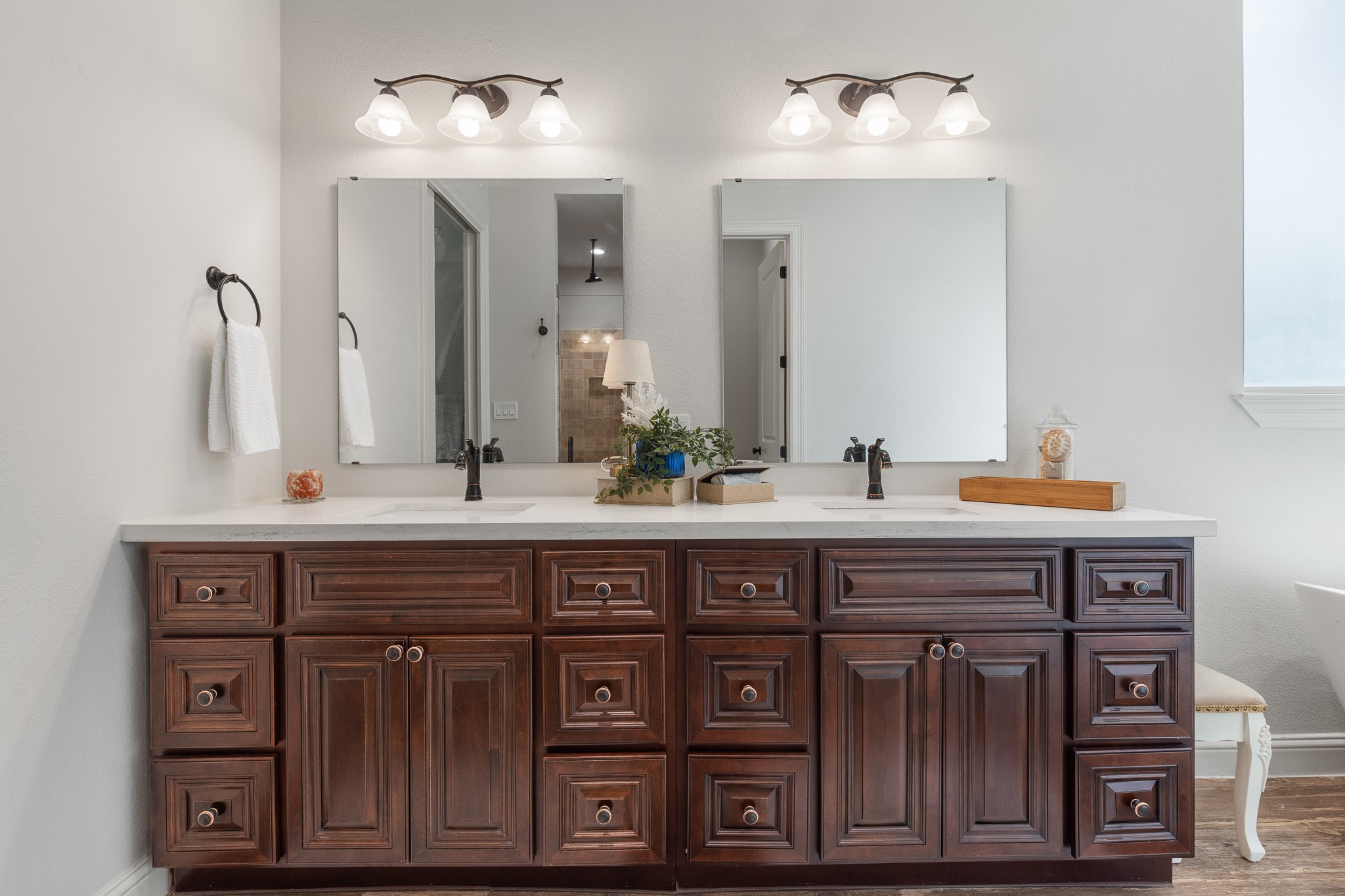 Primary bathroom with custom maple cabinetry throughout all bathrooms.