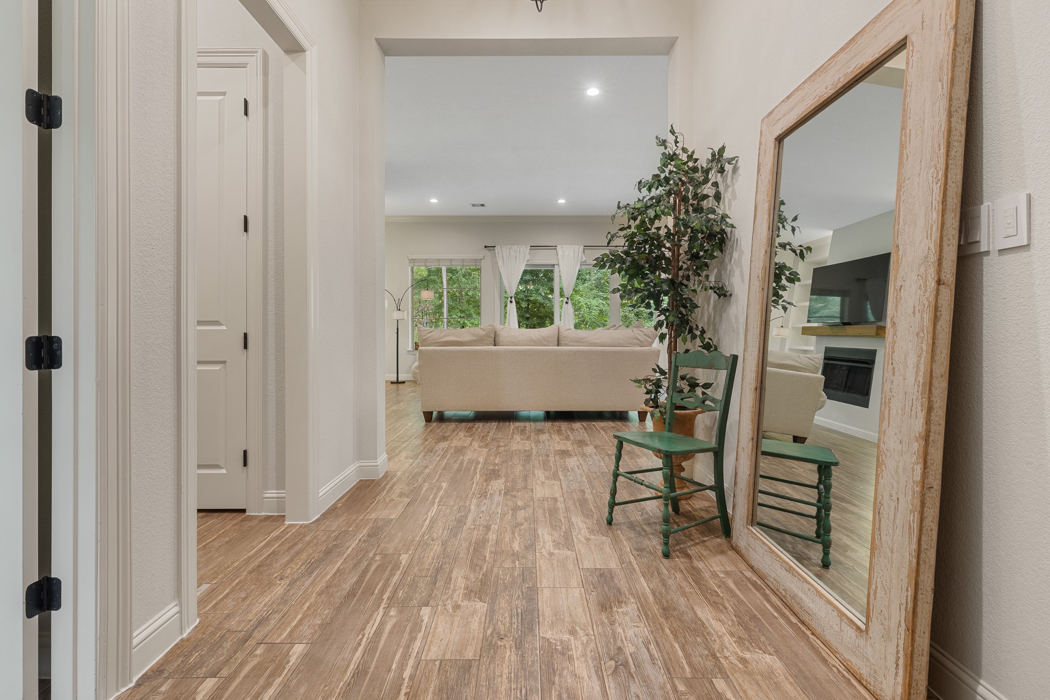 Foyer with chandelier with upgraded dimmer switch. Recessed lighting enhances ambiance.