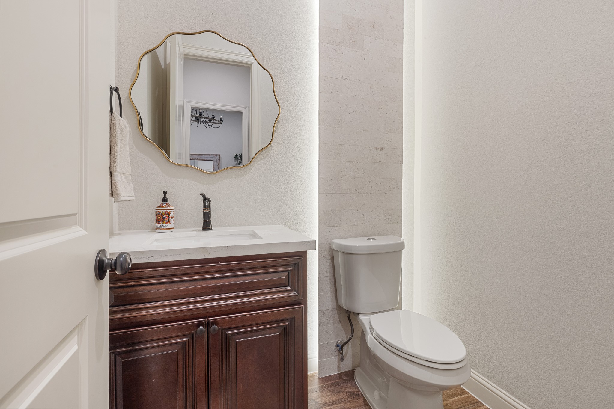 Half bathroom with custom maple vanity.