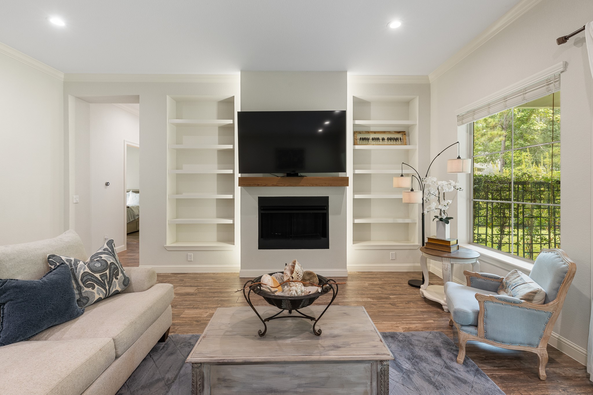 Living room with gas fireplace and built-ins with back lit lighting.