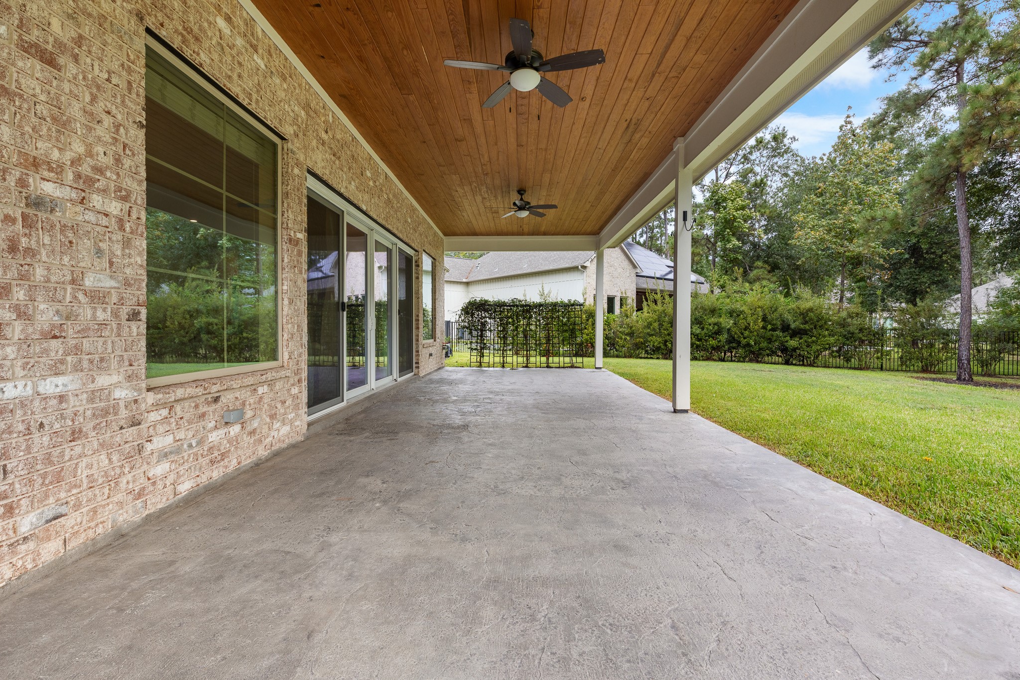 Patio with cedar ceiling and 2 ceiling fan.