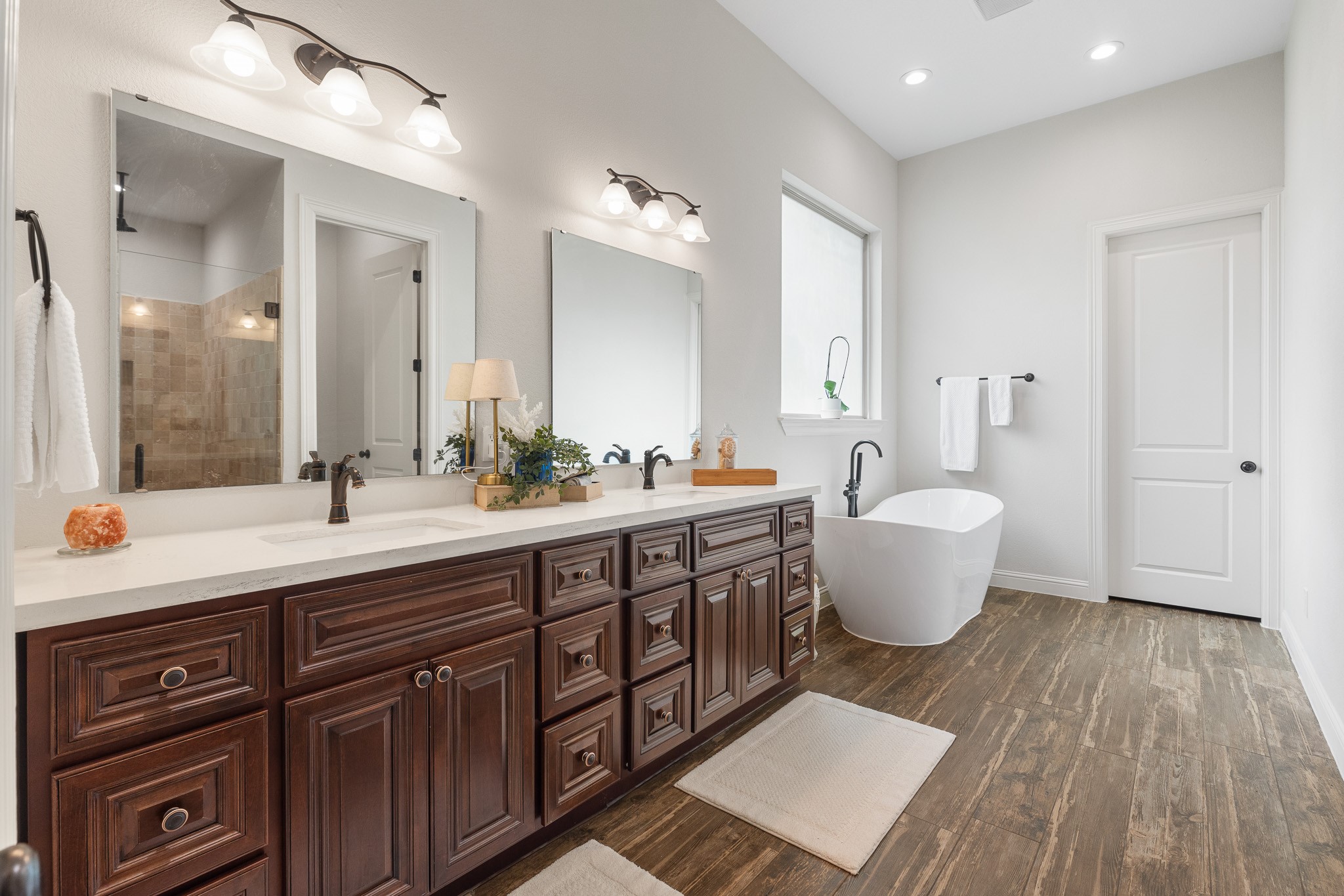 Primary Bathroom with dual sink vanities.