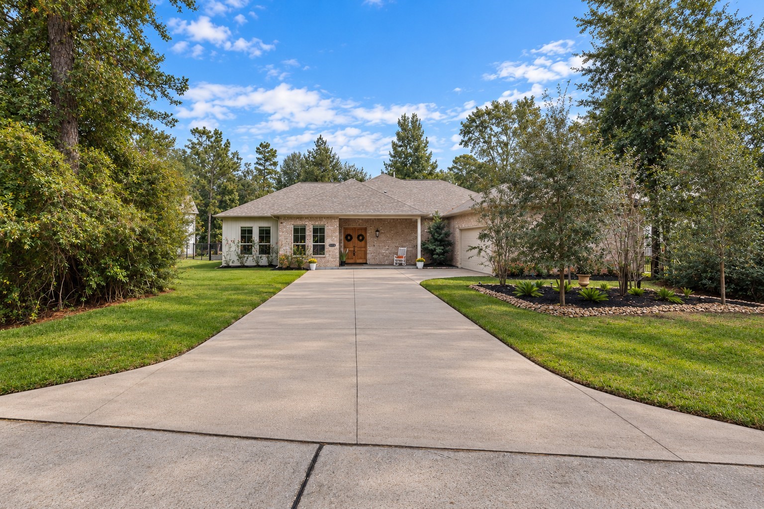 Decorative stone added around front-yard trees, enhancing curb appeal while reducing maintenance and erosion. Boxwood bushes installed next to the garage, designed to mature into a cohesive, elegant hedge that adds structure and visual balance to the landscape.