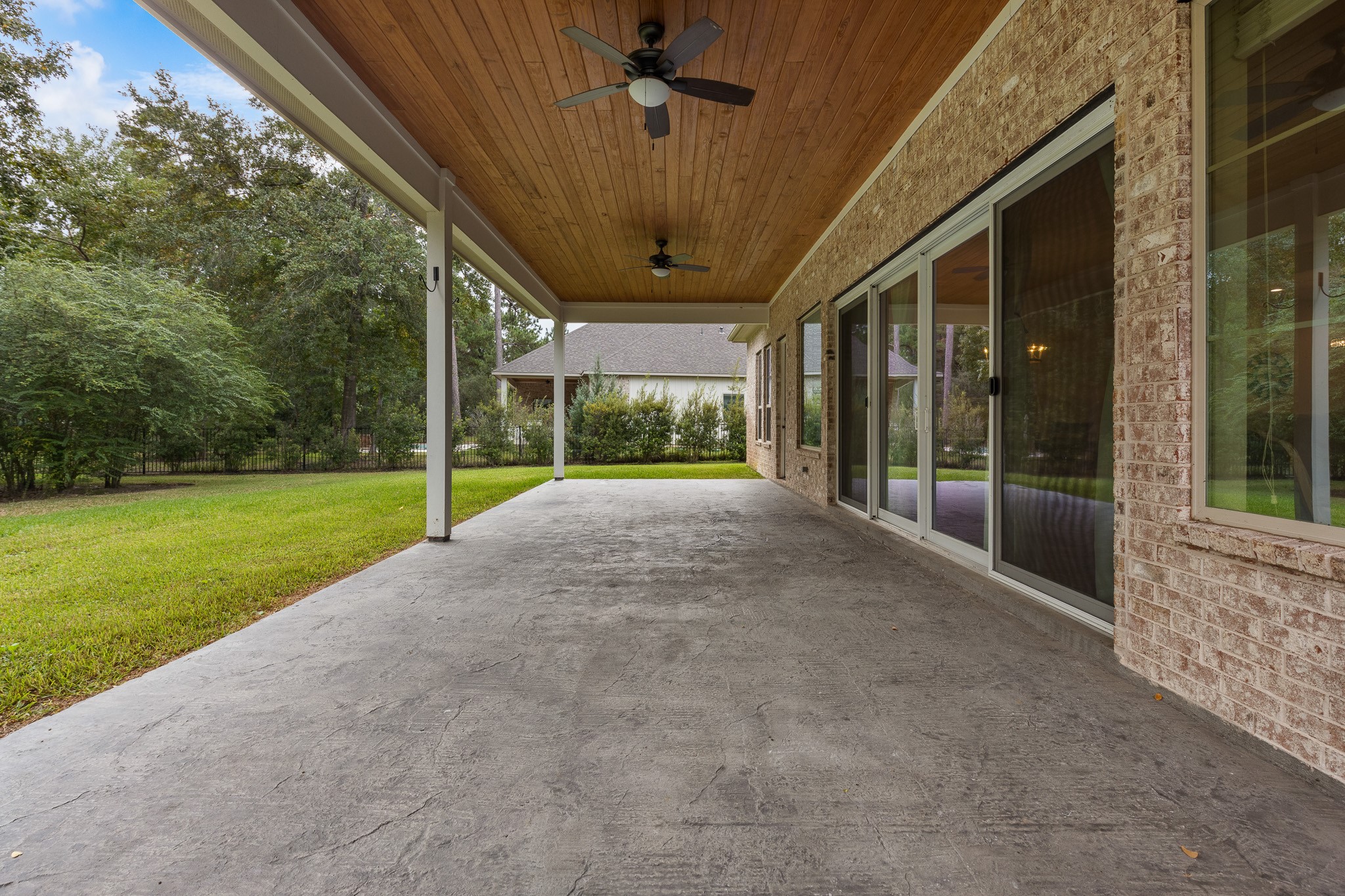 Full-length covered backyard patio.