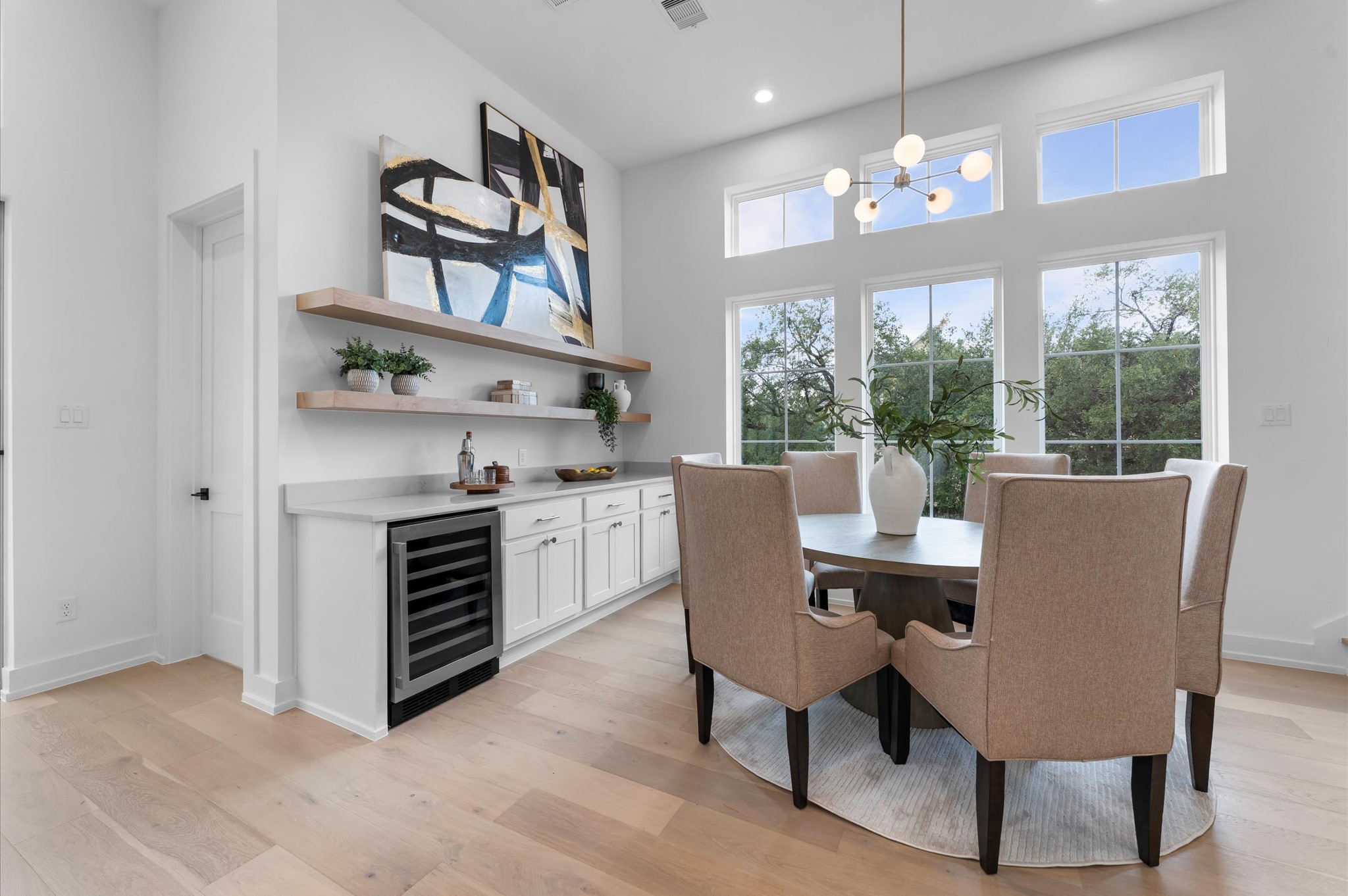 Second floor dining area features a bar with open shelves, wind fridge and plenty of storage.