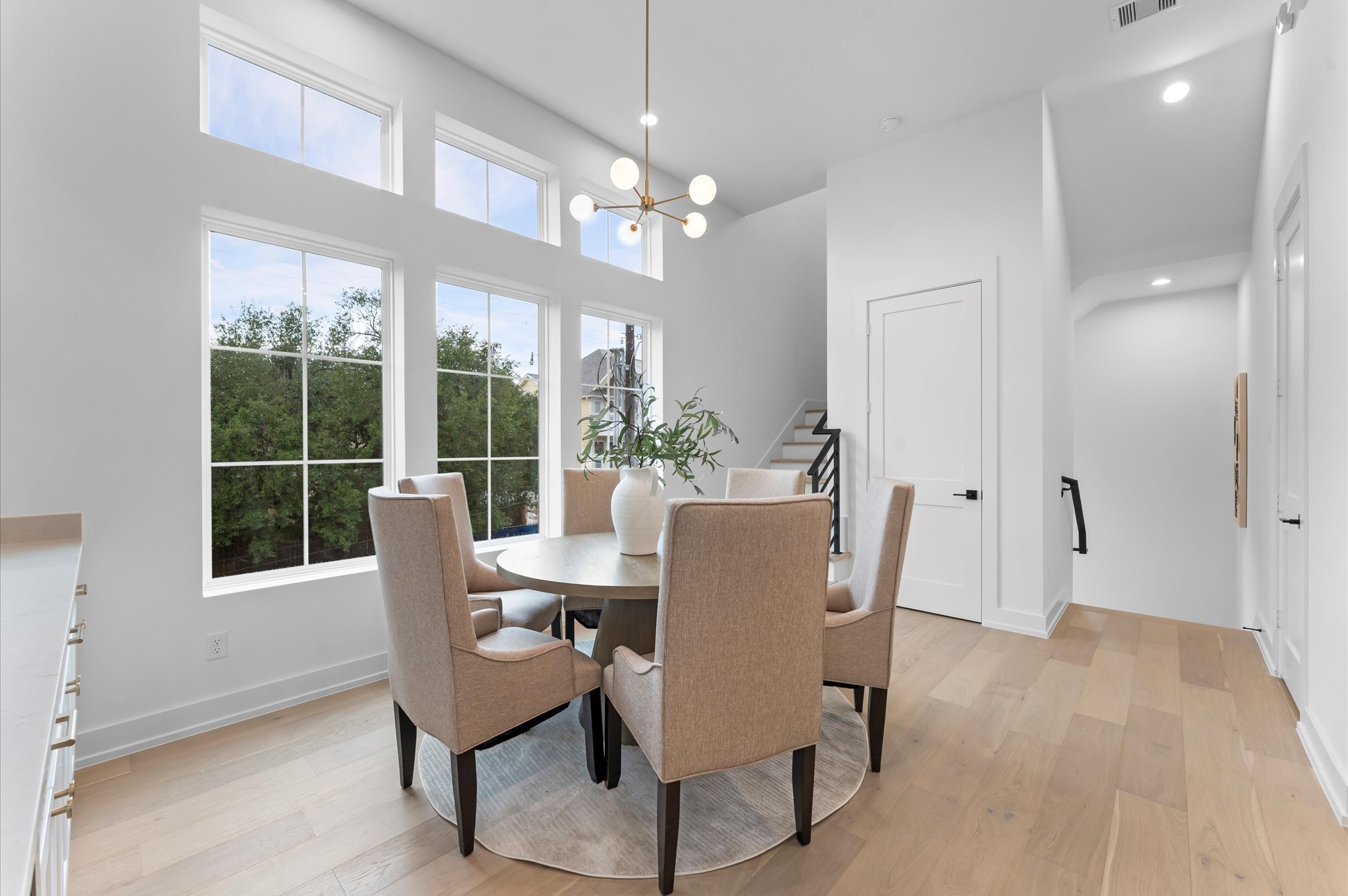 Second floor dining with elevator shaft between stairs.