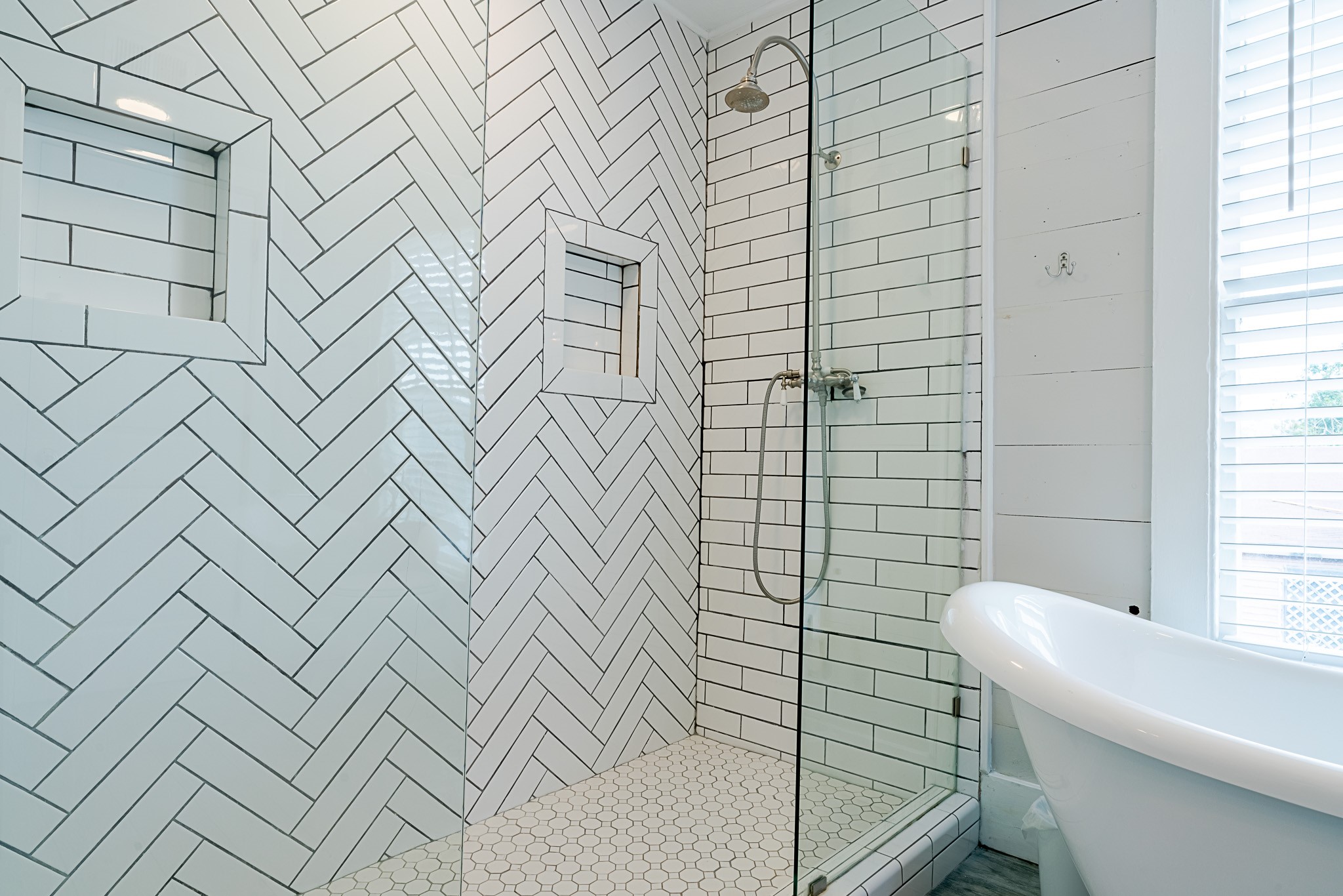 Beautifully upgraded primary bathroom with fully tiled stand alone shower